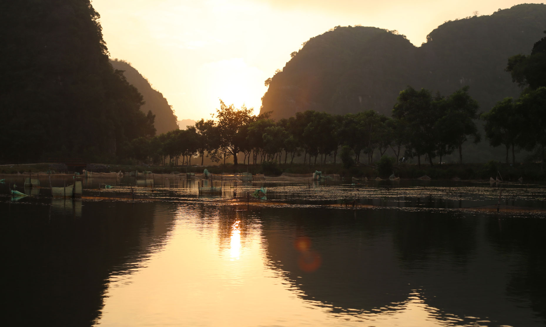 Sunset at Tam Coc, Vietnam. We took a romantic boat ride for three.