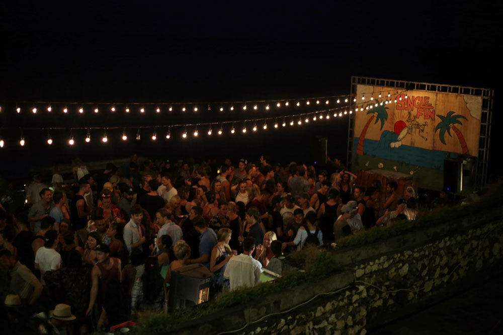 Bar-goers watching surfers at sunset (top), and Single Fin dance party (right)