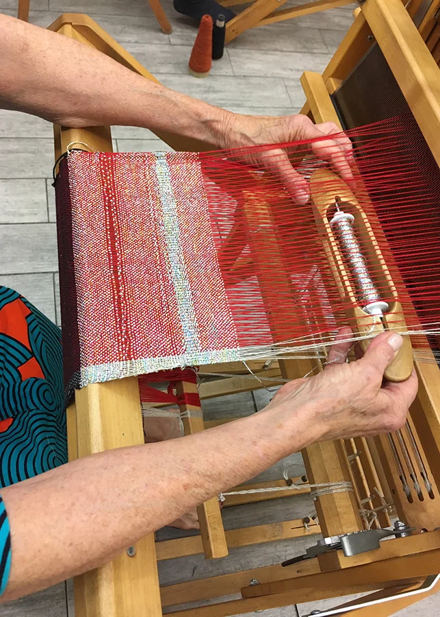student weaving on a floor loom in Weaving 101 class at the Textile Arts Center, 2018