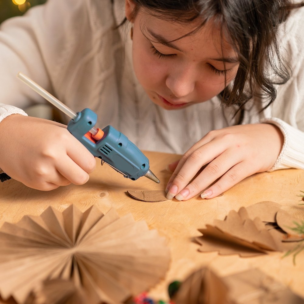 girl-makes-christmas-tree-decorations-out-of-paper-2023-11-27-05-04-34-utc.jpg