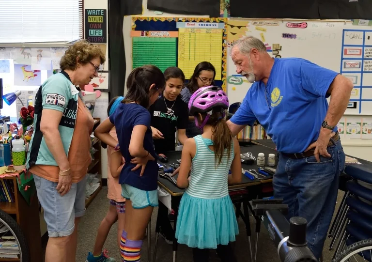 Kiwanis Bike Program's Roger Jacobson teaching Bike Like a Girl campers about bikes. 