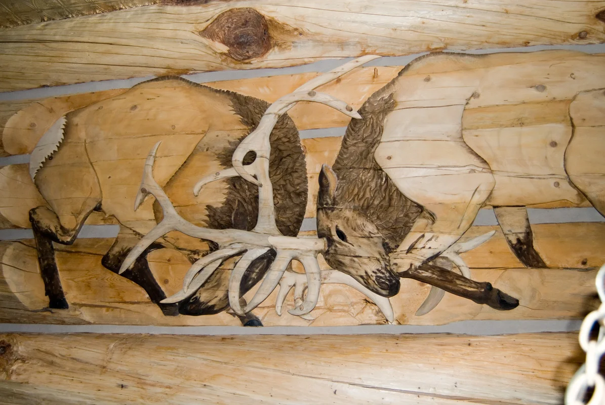 "Rutting elk" Carved into the wall of a mountain lodge