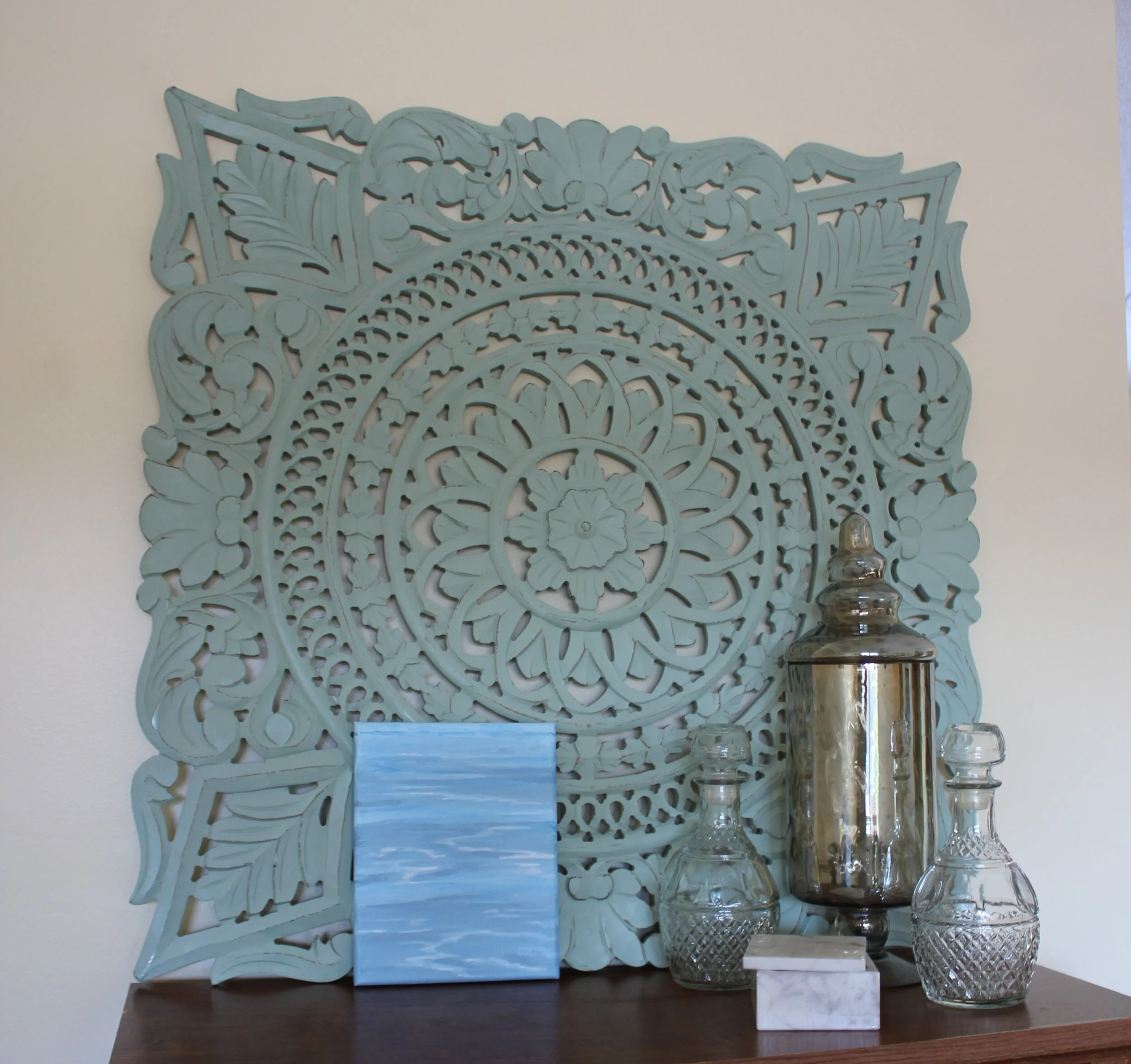 Varying shades of light blue ocean scene with glass jars