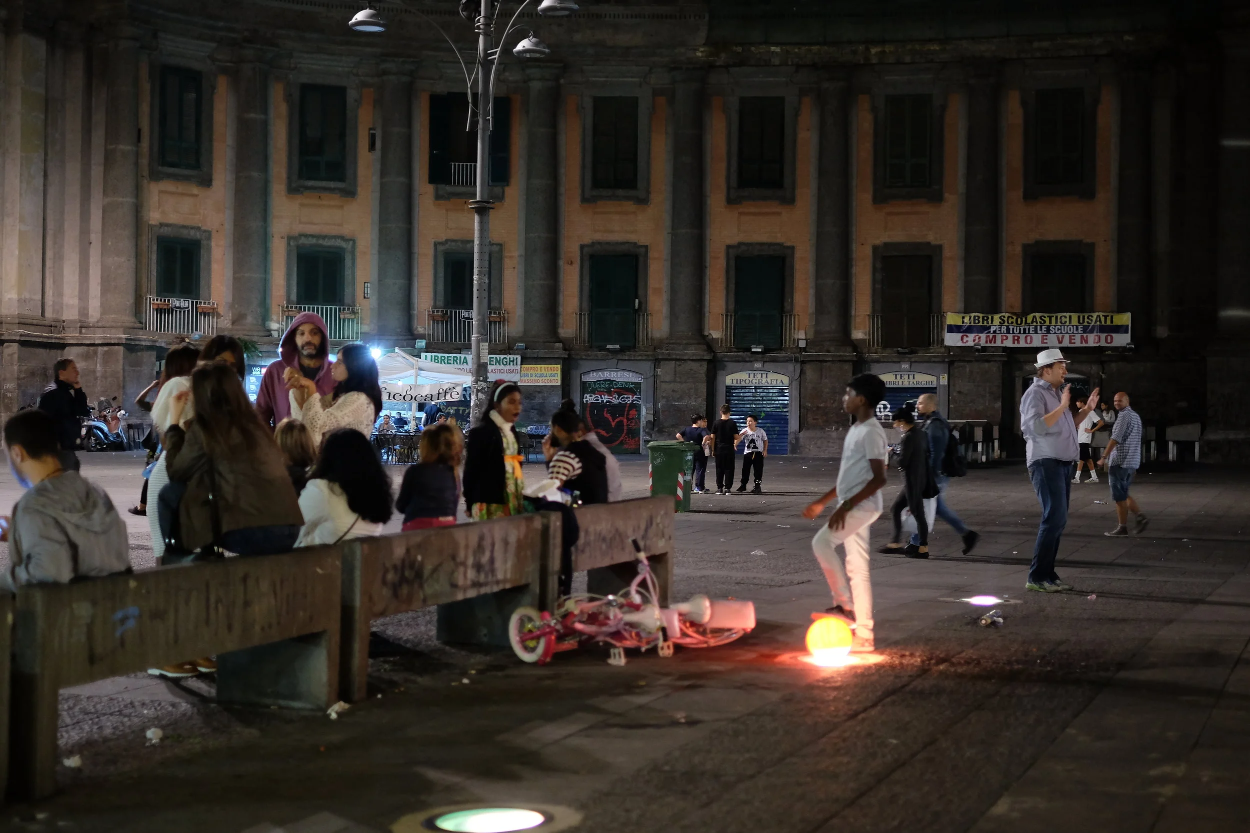Kids playing football in piazza Dante until late.