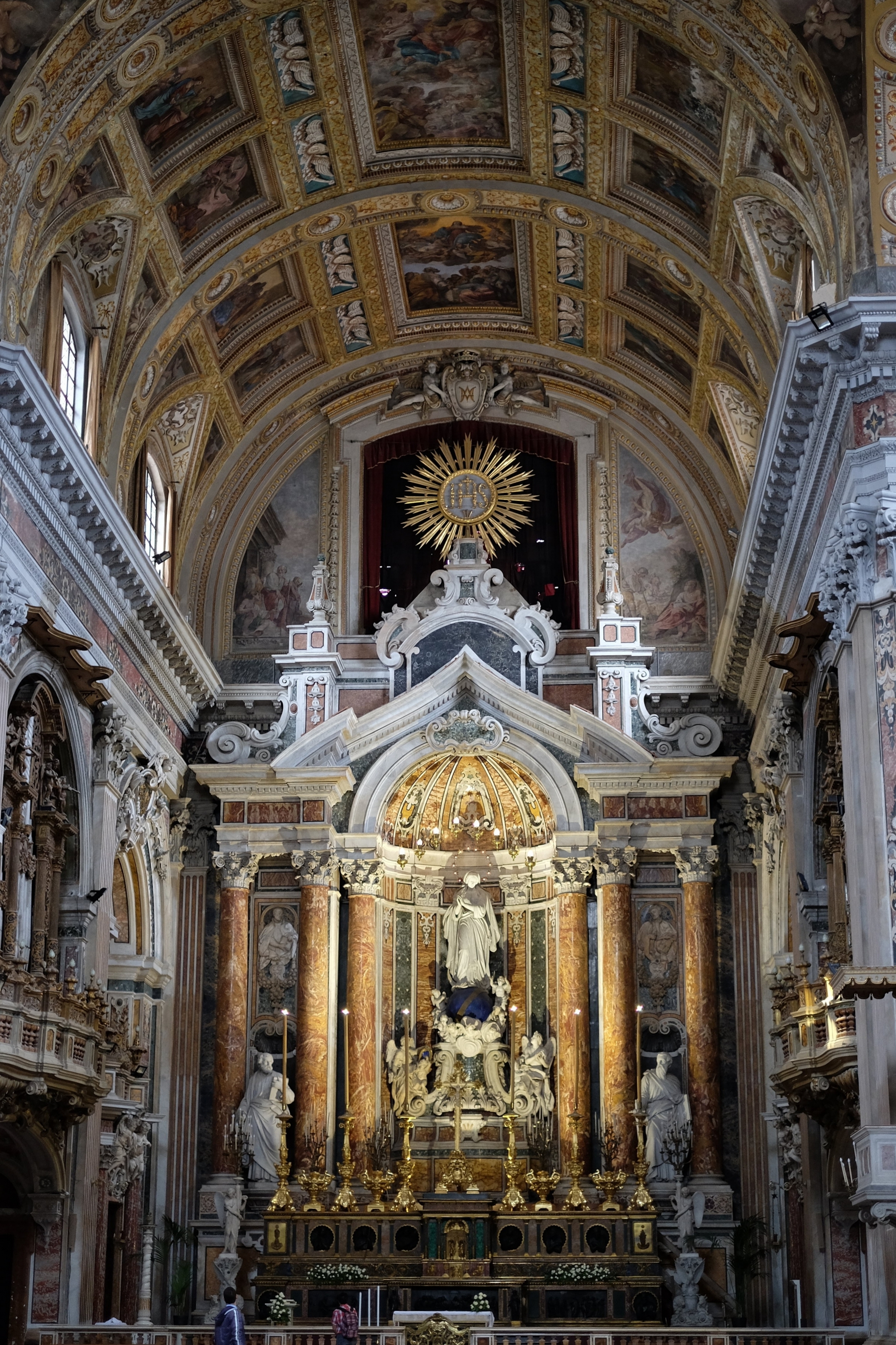 The high altar with the sculptures of The Madonna and Saint Peter and Saint Paul by Antonio Busciolano, dated 1857-59. The ceiling-dome is decorated with paintings by Massimo Stanzione.