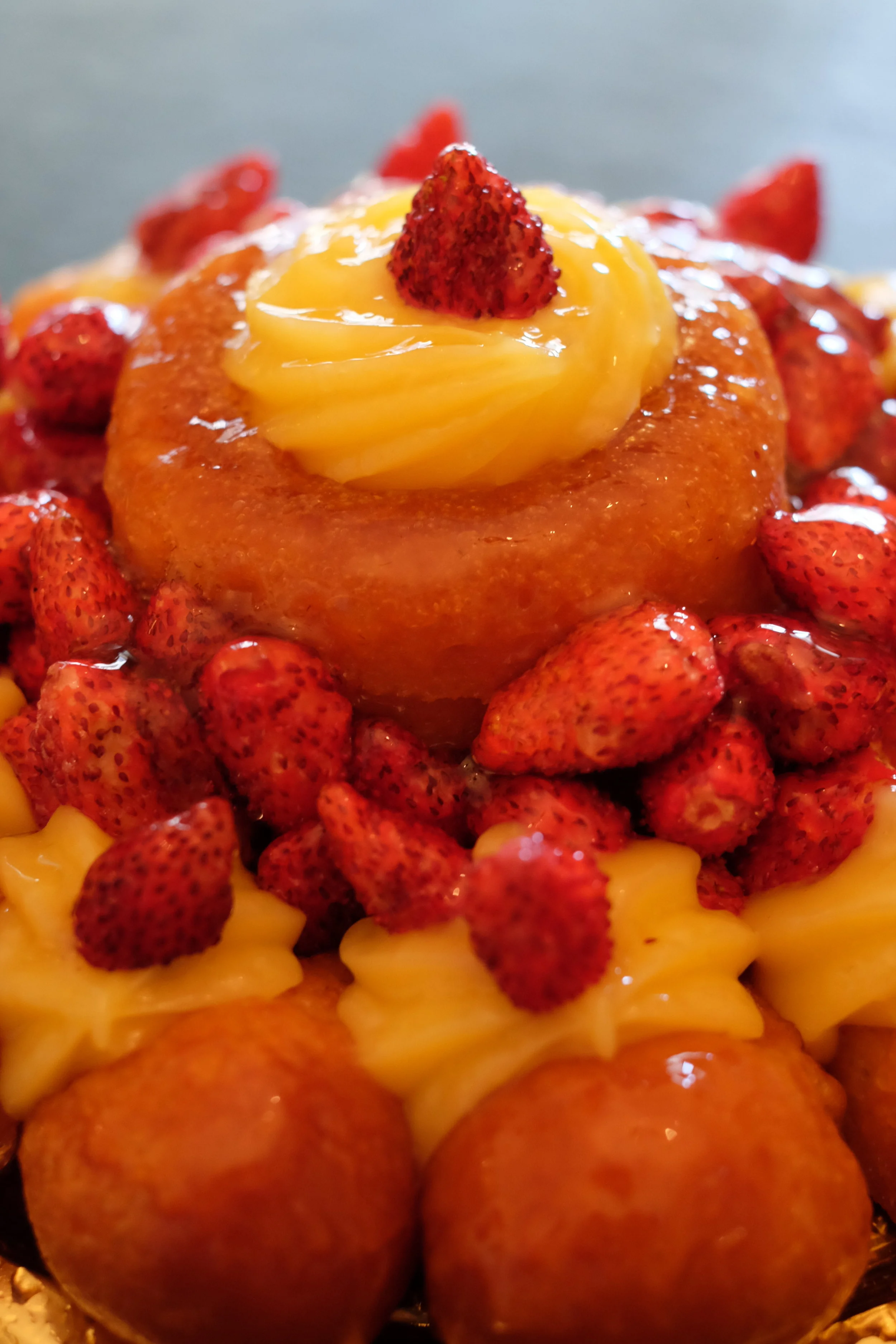 Rum baba with custard cream and little strawberries cake.
