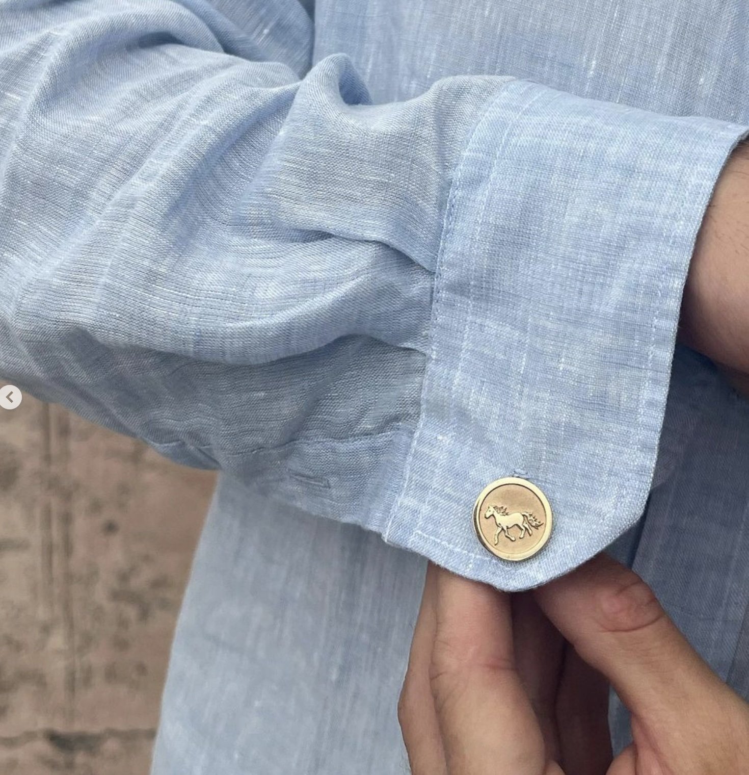 gold horse cufflinks on model.jpg