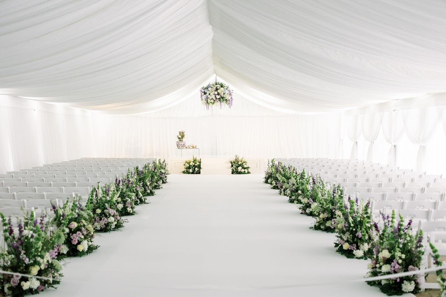 This formal wedding aisle was as clean and crisp as they come. The florals balanced perfectly by blending whites, lavenders and soft green hues against layers of luxurious white fabrics. 

Floral: @festivestl 
Planning: @kateandcompany 
Photo: @mikec