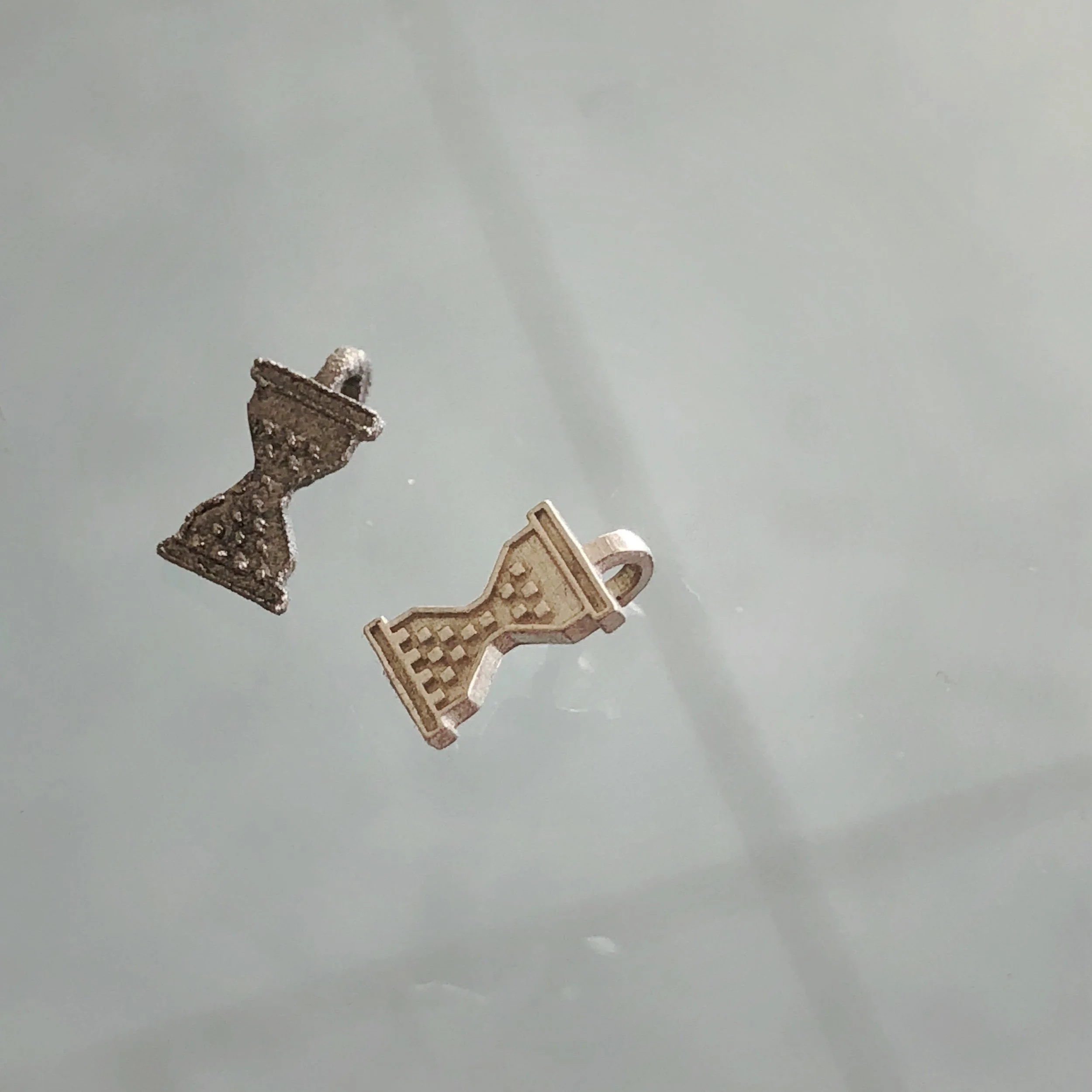 DMLS 3D print in titanium and 3D printed wax that has been cast in silver. 