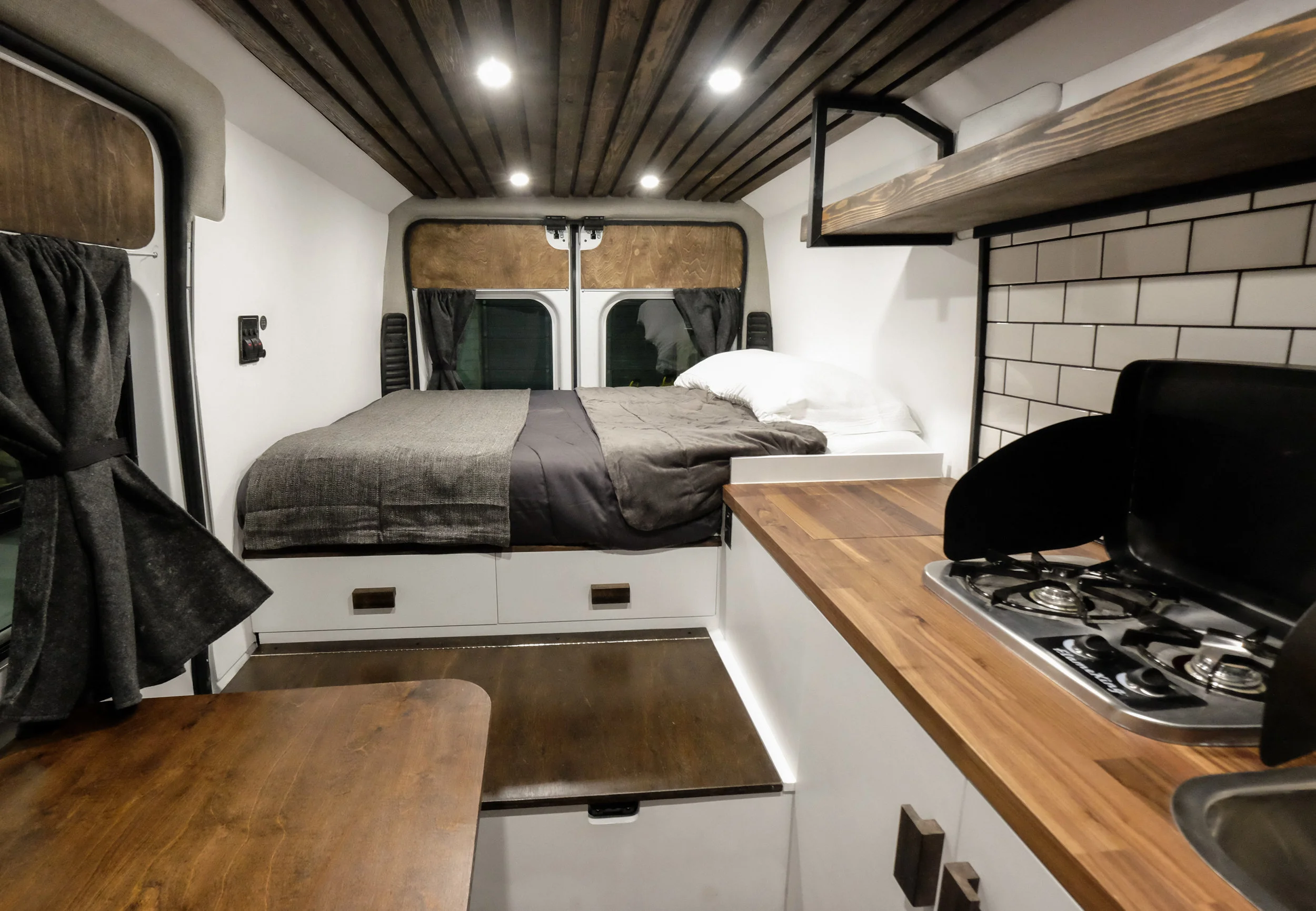 A stow-away pedestal table offers enough space for two while being easily stored away at night or while on the road. 