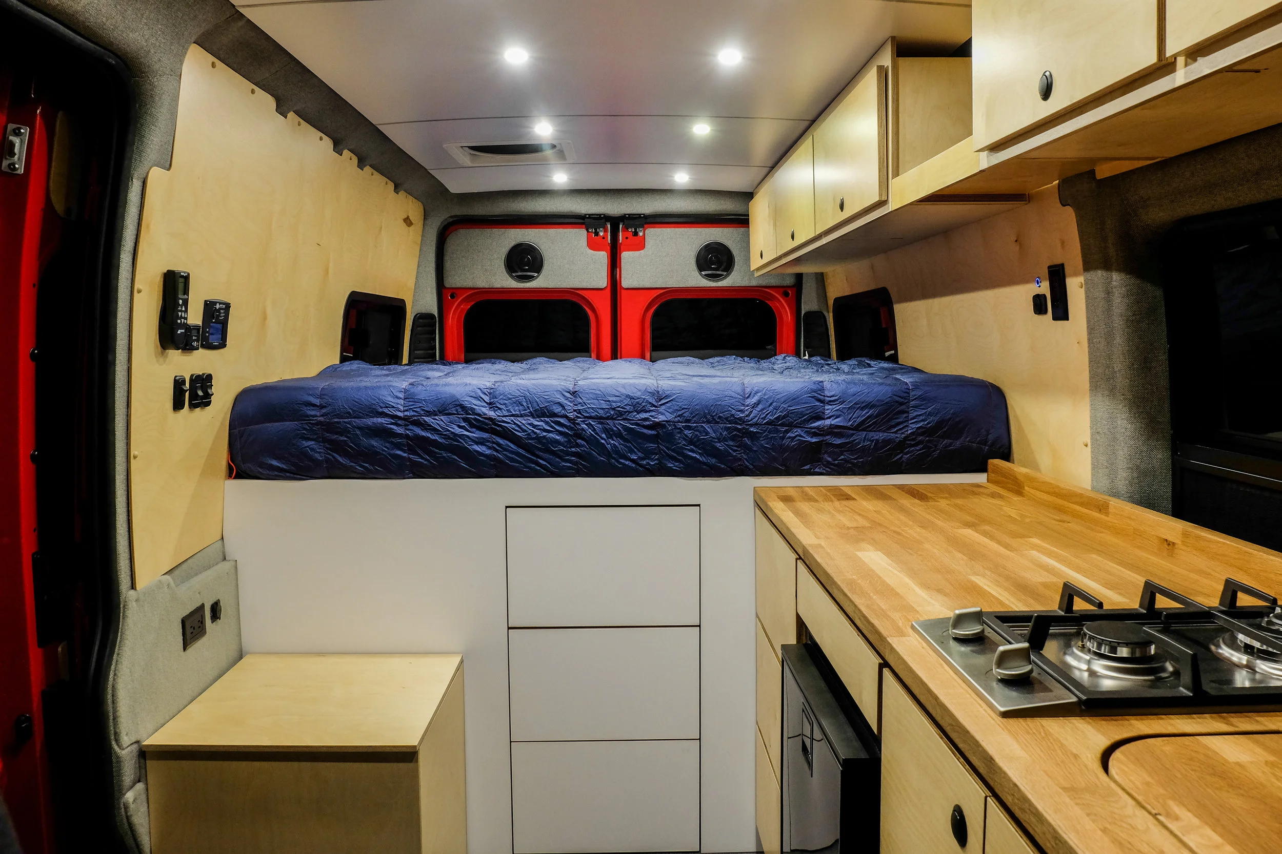 A 6" queen+ memory foam mattress sits on top of an elevated 36" bed platform. The elevated bed allows room for Rob's two mountain bikes to be safely stowed using the RockyMounts bike storage system. 