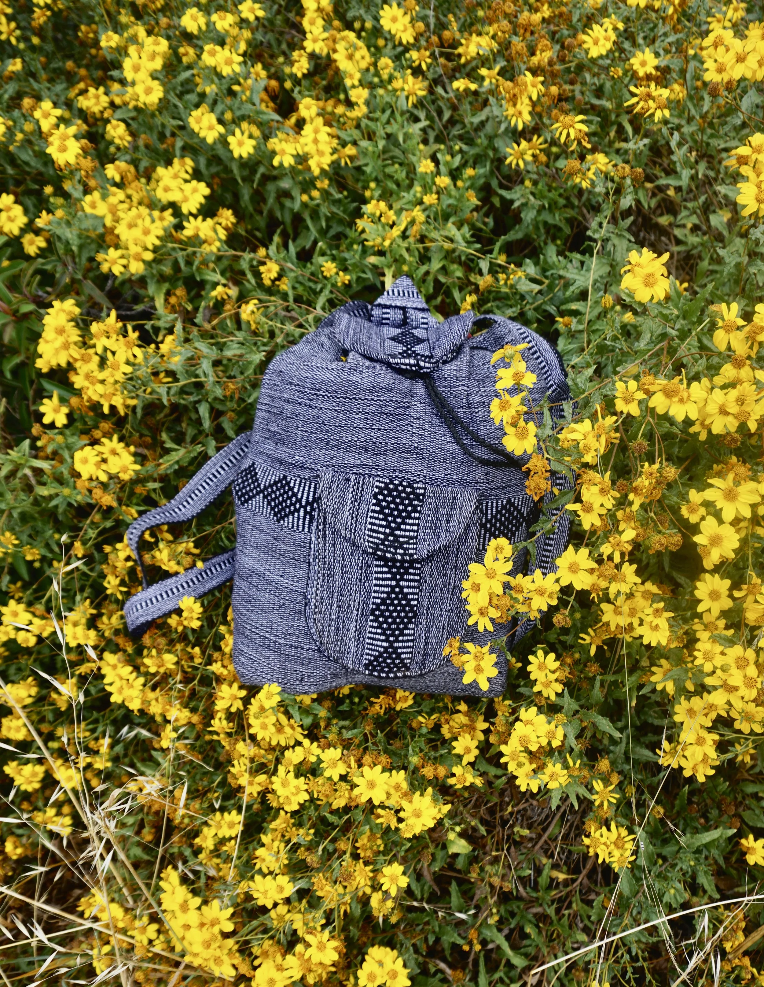 Baja Roots backpacks have a front zipper pocket, a chord on the top and pin to close the bag and keep it closed. They are coming out with a new prototype that will be for water sports and for hiking, I'll keep you informed. 