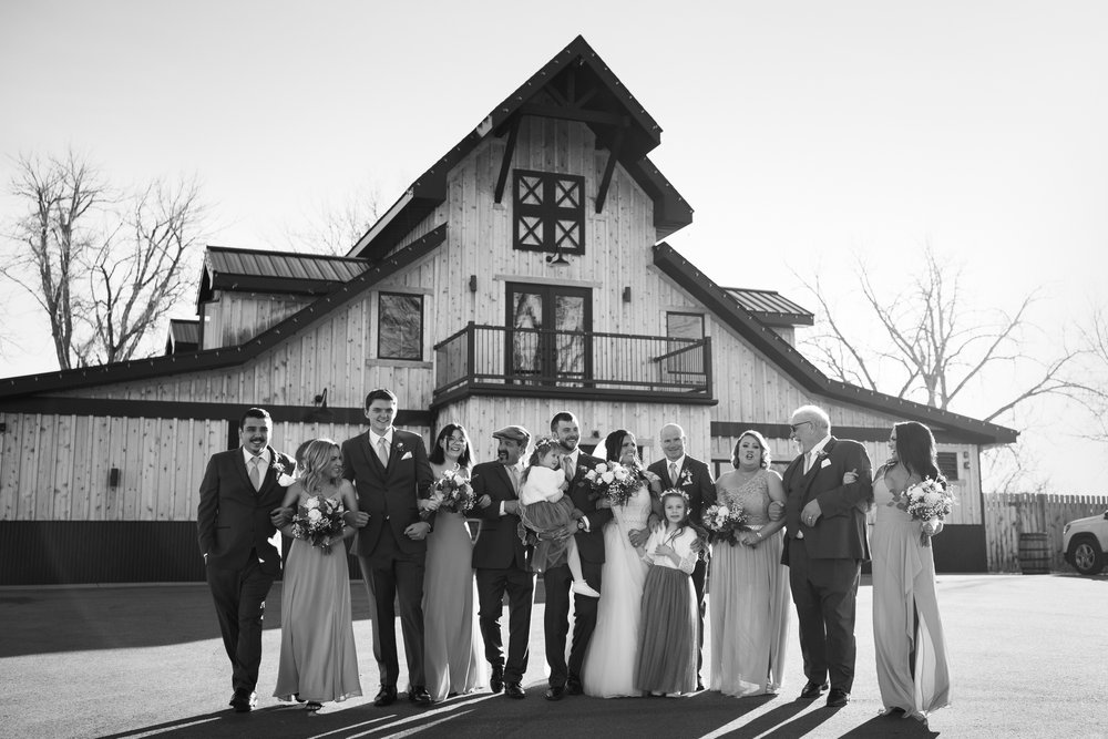 Bridal party with children smile at wedding venue Camelot Ranch