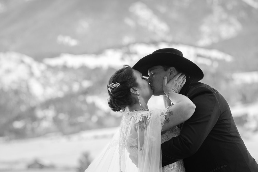 Bride and groom kiss out West in Montana.