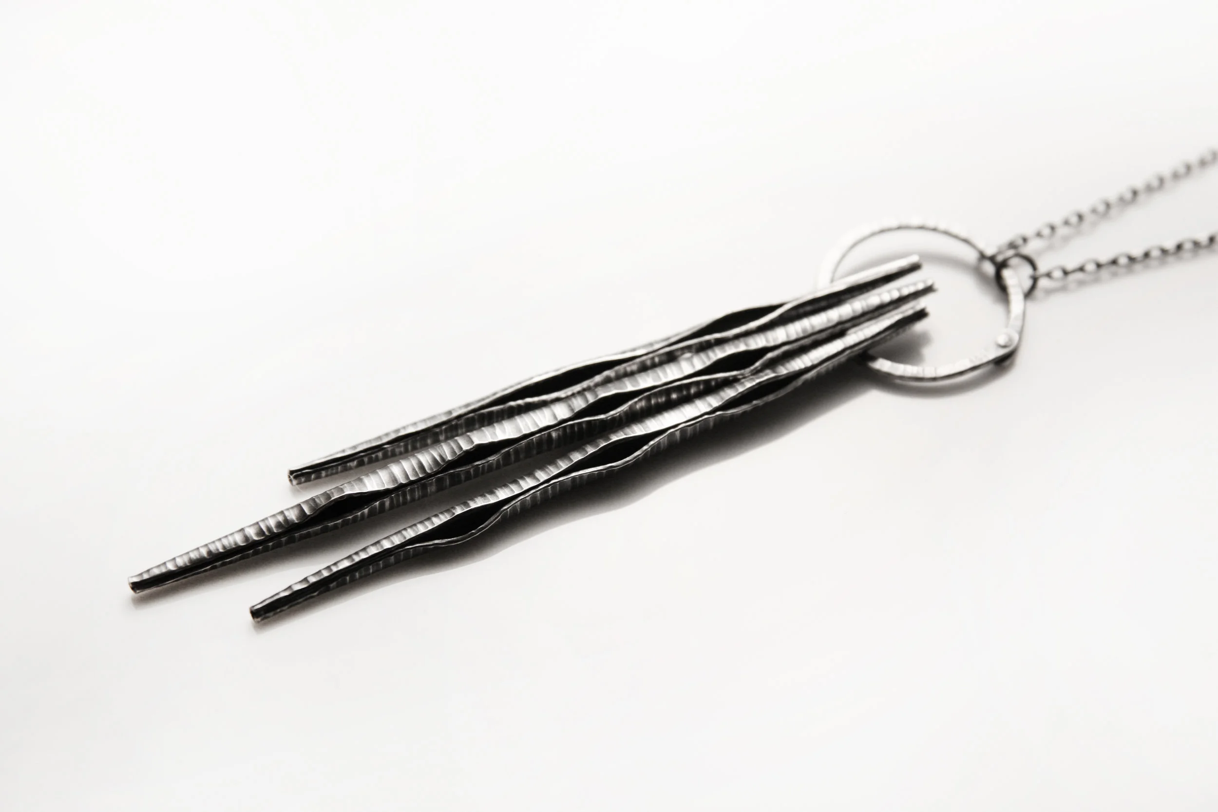 triple_zebra_pod_necklace_detail_light.jpg