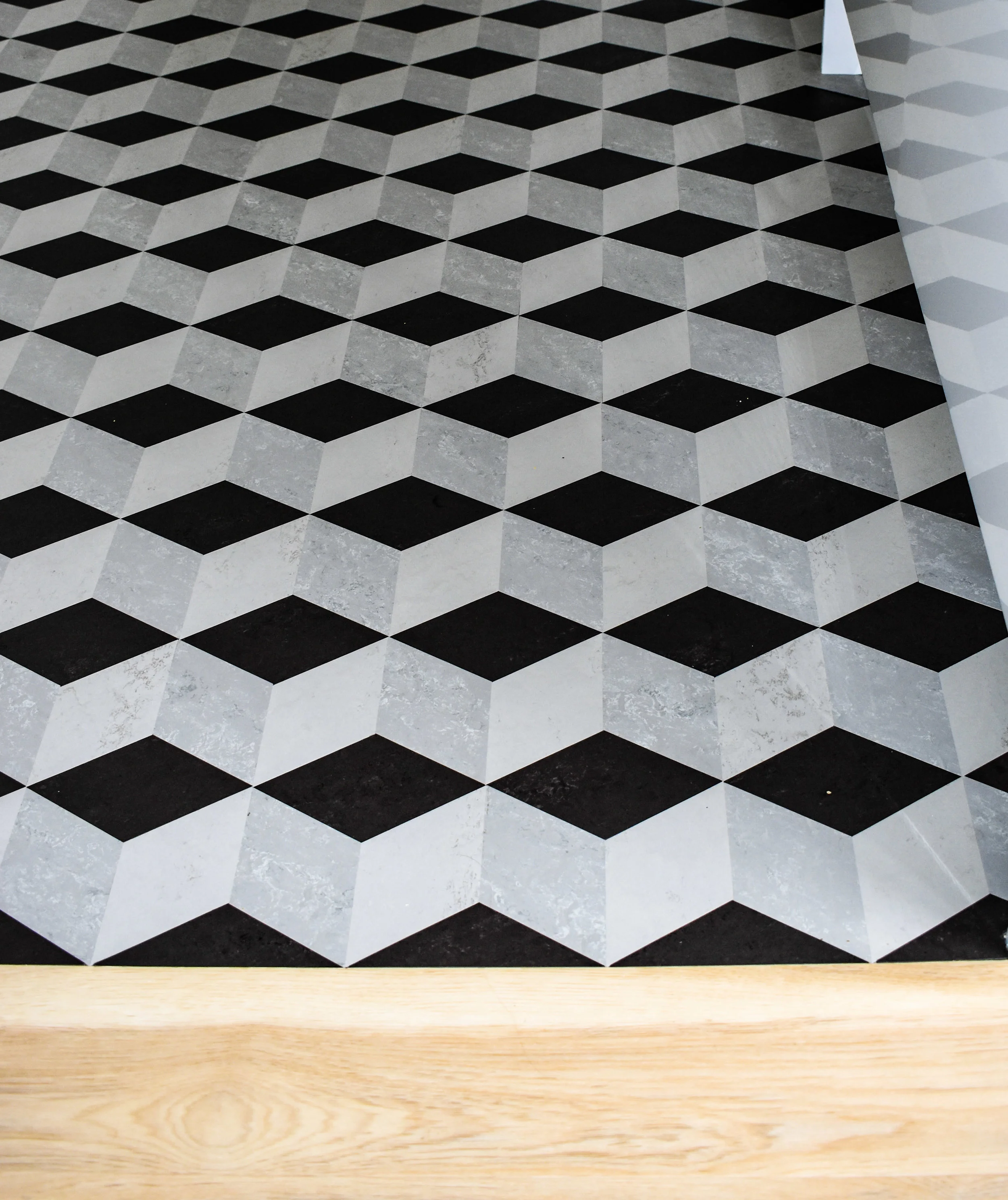  Flooring transition between Light Oak Amtico and a bespoke Forbo Marmoleum floor designed by Four Walls 