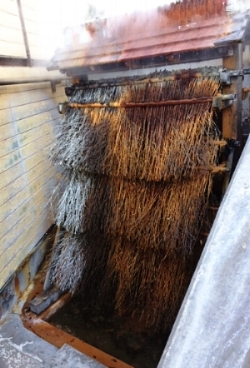 Traditional onsen cooling station. The water is poured over the branches to cool.