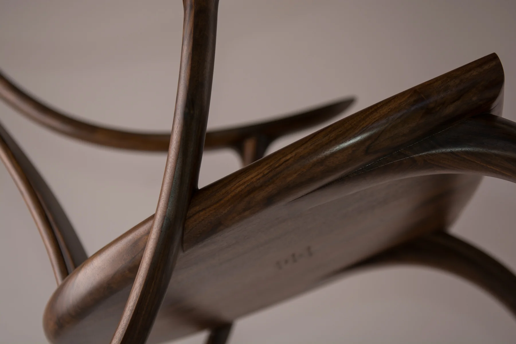 The Monogram Rocking Chair is signed and dated under the seat.