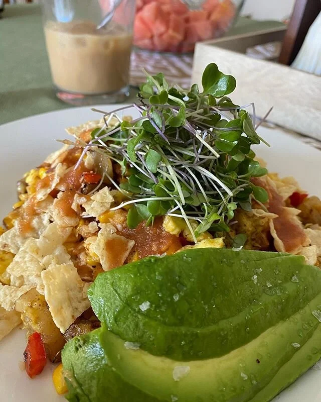 When chilaqueles and hash join forces, shall we call them &ldquo;Hashqueles&rdquo;? | Russet potatoes, red bell peppers, grilled sweet corn, scrambled eggs with cheese topped with homemade salsa, bottom of the bag tortilla chips, sprouts and avocado 