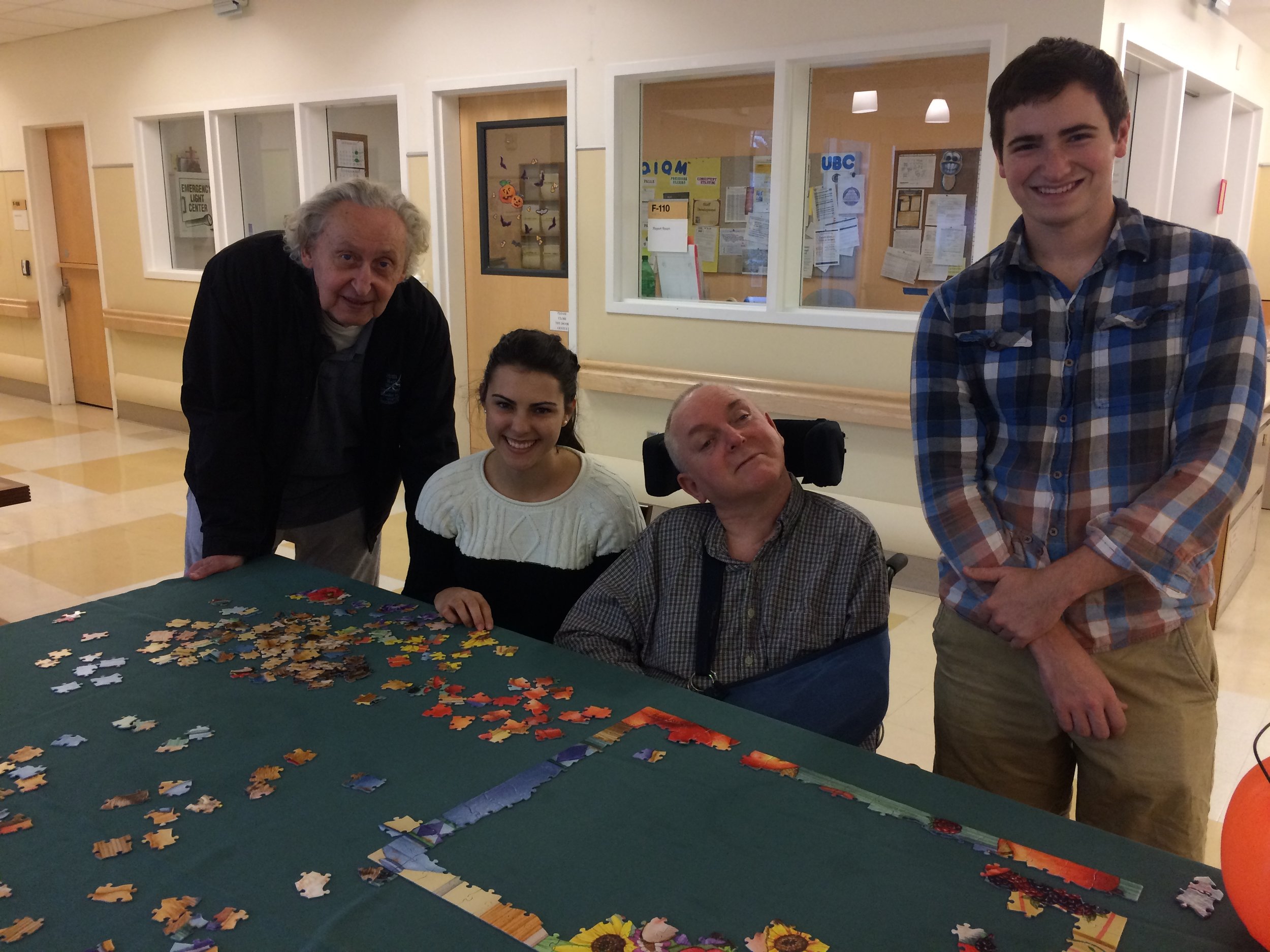 Volunteers building a puzzle with veterans at the Menlo Park Veteran's Hospital.