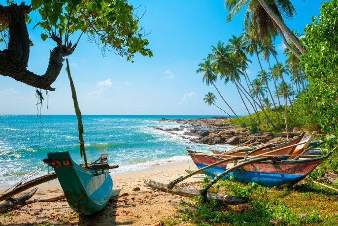 Untouched-tropical-beach-with-palms-and-fishing-boats-in-Sri-Lanka-686x459.jpg