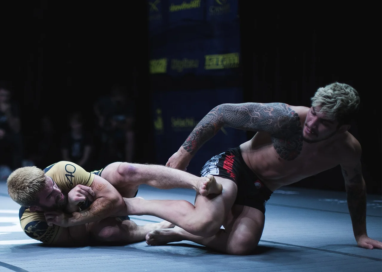 in the main event, two of the most compelling figures in no-gi BJJ, Garry Tonon of John Danaher's’ New York ‘Death Squad’ and Conor McGregor's jiu-jitsu trainer Dillon Danis clash on British shores. This image epitomises the match, with Danis extricating himself from a leglock as Tonon wages his assault. Both this match and the co-main event featuring Dan Strauss against Jake Shields saw the Death Squad competitors apply a relentless pressure game, leaving no doubt as to the judges' decision despite no submission finish. Photo by Luke Jarvis .