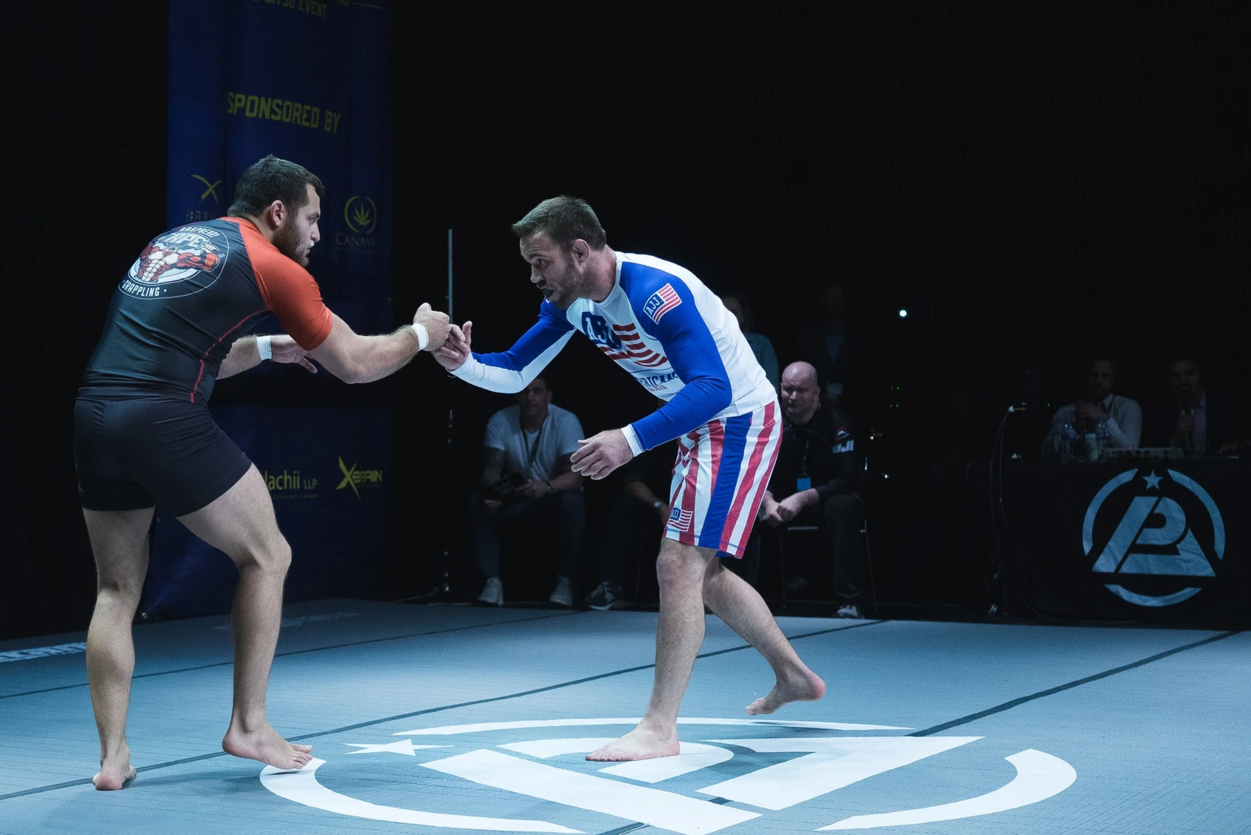 Charismatic UK star Dan Strauss of Mill Hill BJJ, London puts on a game display against grappling maestro and MMA stand-out Jake Shields, but loses by majority decision. Shields' super-coach John Danaher looks on. Photo by Luke Jarvis .