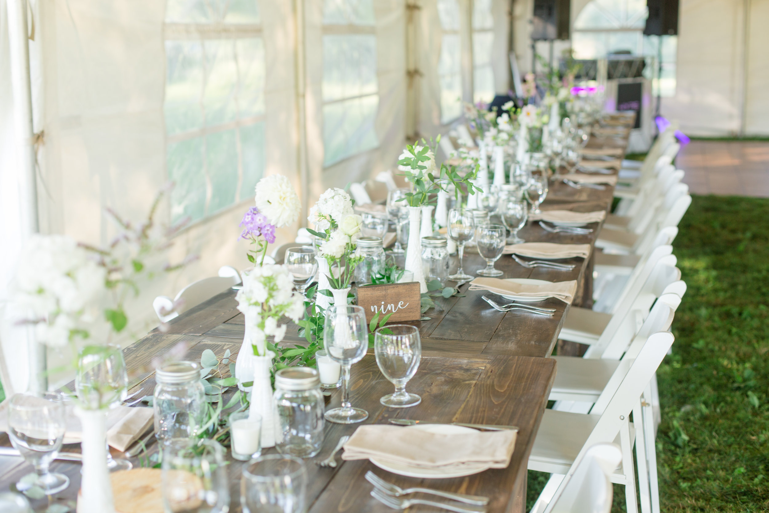 Varying size and style vintage milk glass vases Wooden script table numbers Photo by Nicole Anne Photography
