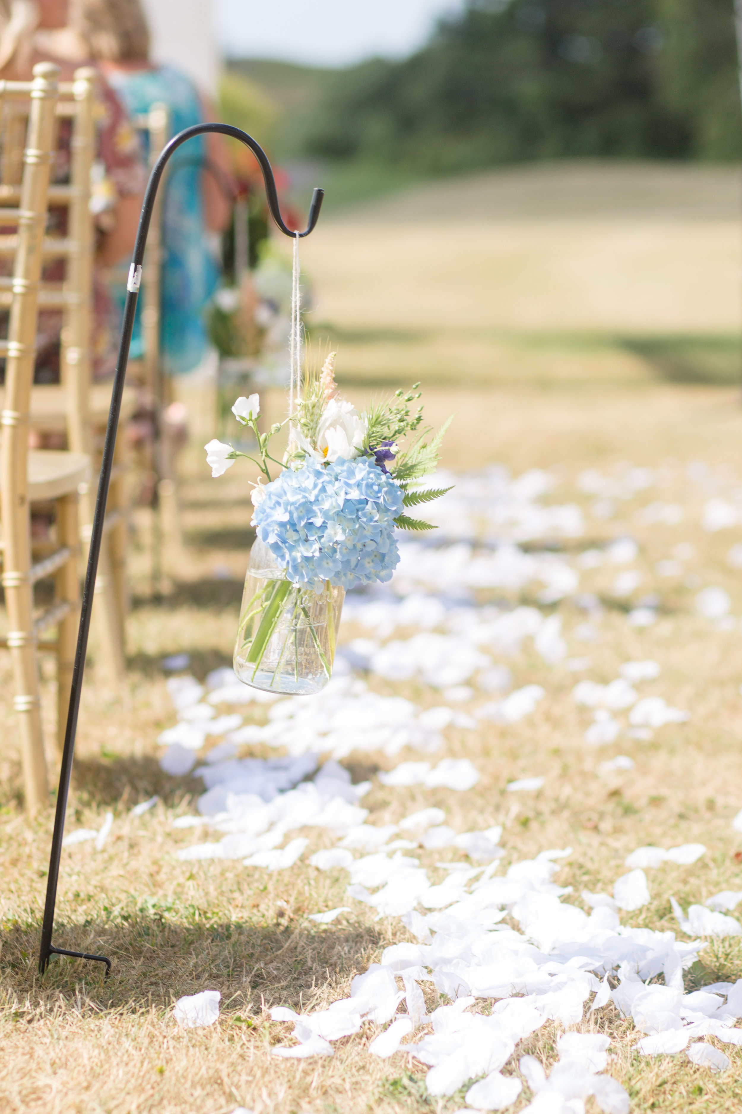 Shepherd’s hooks Assorted size mason jars for vases or candle holders Photo by Nicole Anne Photography