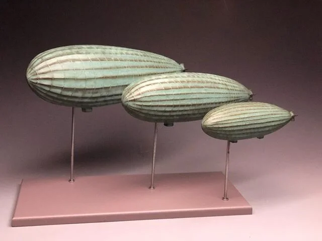 A group of zeppelins floating off to their new home in California.Stoneware clay and glazed in weathered bronze.I am half way through my limited run of these guys.Message me if interested.These are displayed on a stand and can be hung on a wall.#oddi