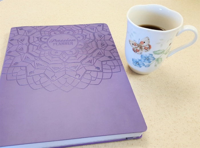 Here's how my workdays start. I pour myself a hot beverage, and I assess my plan. (I used the black Passion Planner my first year, but this year I went with the purple one. The layout is the same.)
