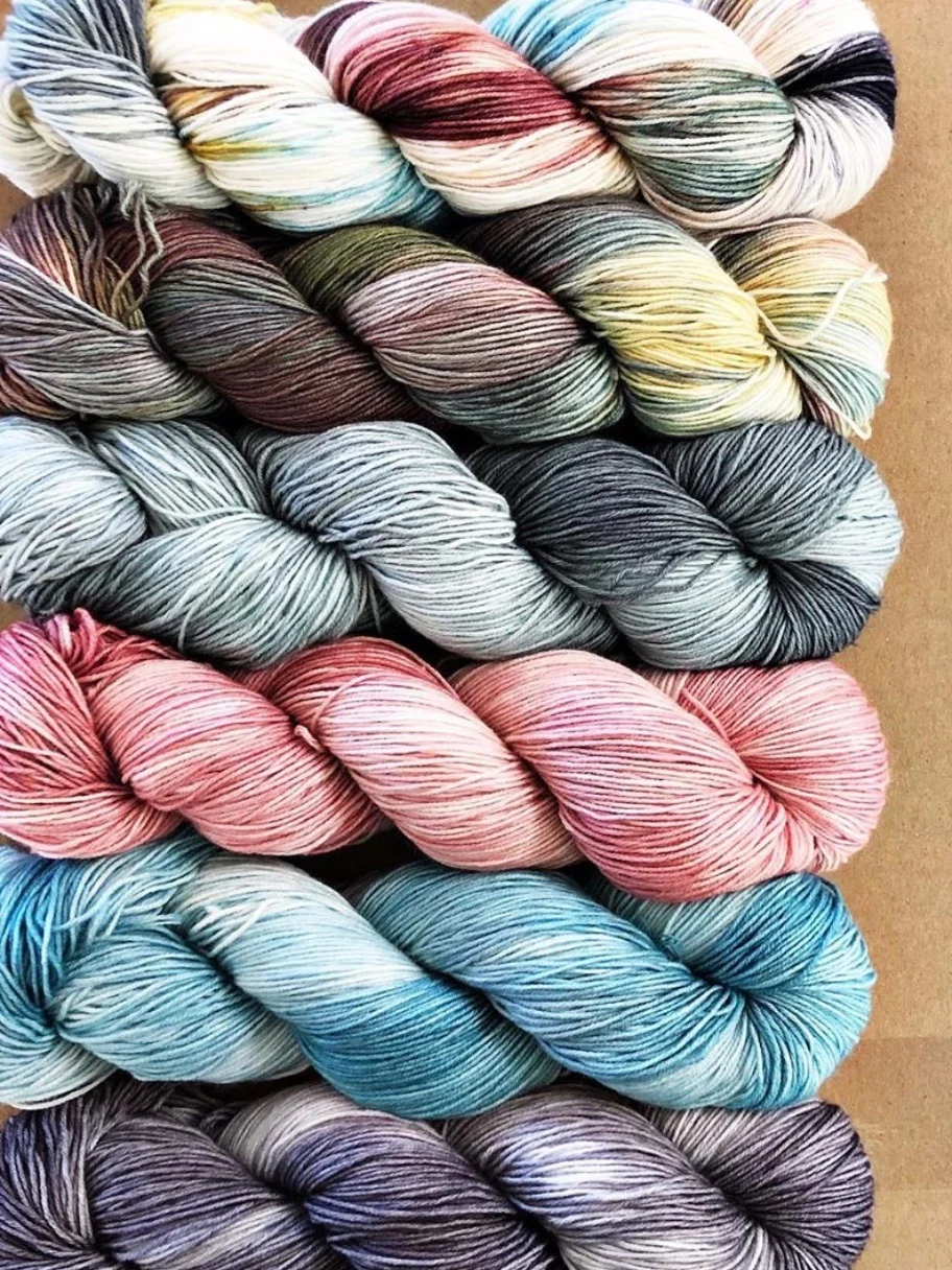 Forbidden Fiber Co. exquisite flat lay up of some of her hand dyed yarns.