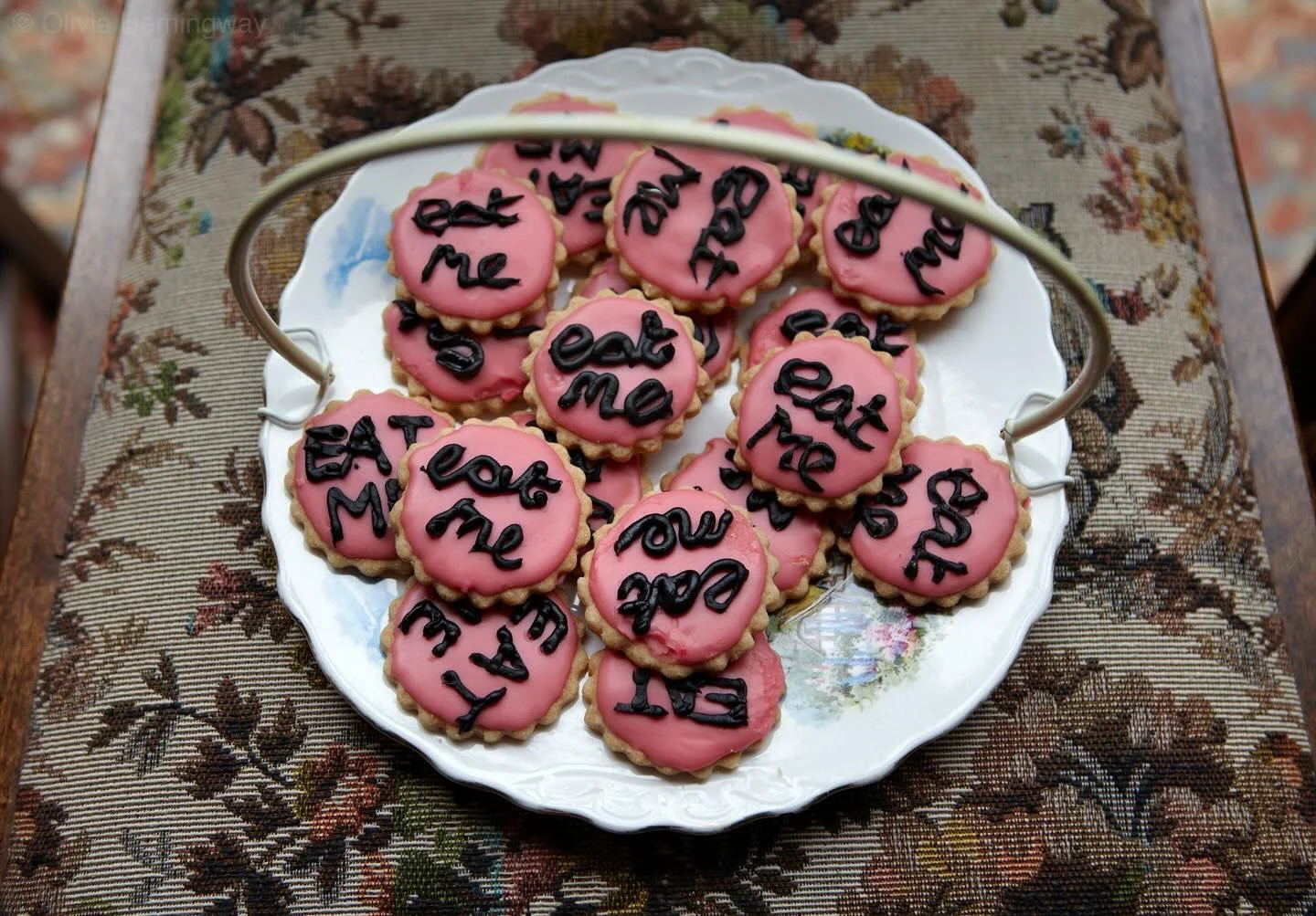 Some of my 🧁 images from the archive that will soon be in @millennium_images 🩷 Love the pattern of the chair with the &lsquo;Eat Me&rsquo; cakes on top. It&rsquo;s the details that get me.

#EatMe
#MadHattersTeaParty 
#CakePhotography
#PhotoArchive