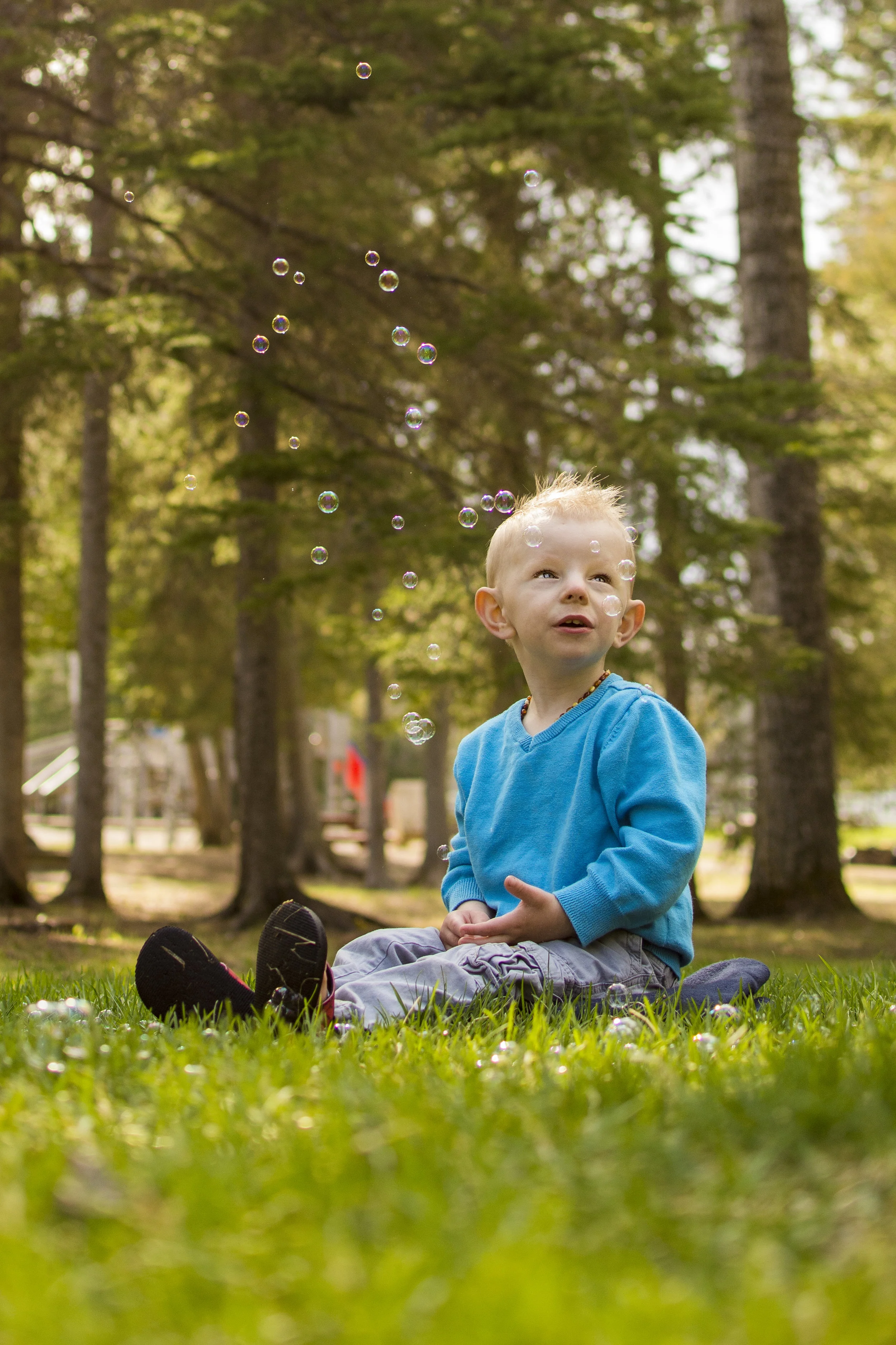 Photo of a boy sitting enjoying the bubbles taken at Centennial Park in Thunder Bay