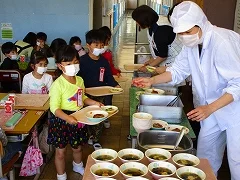 Being served by school staff.