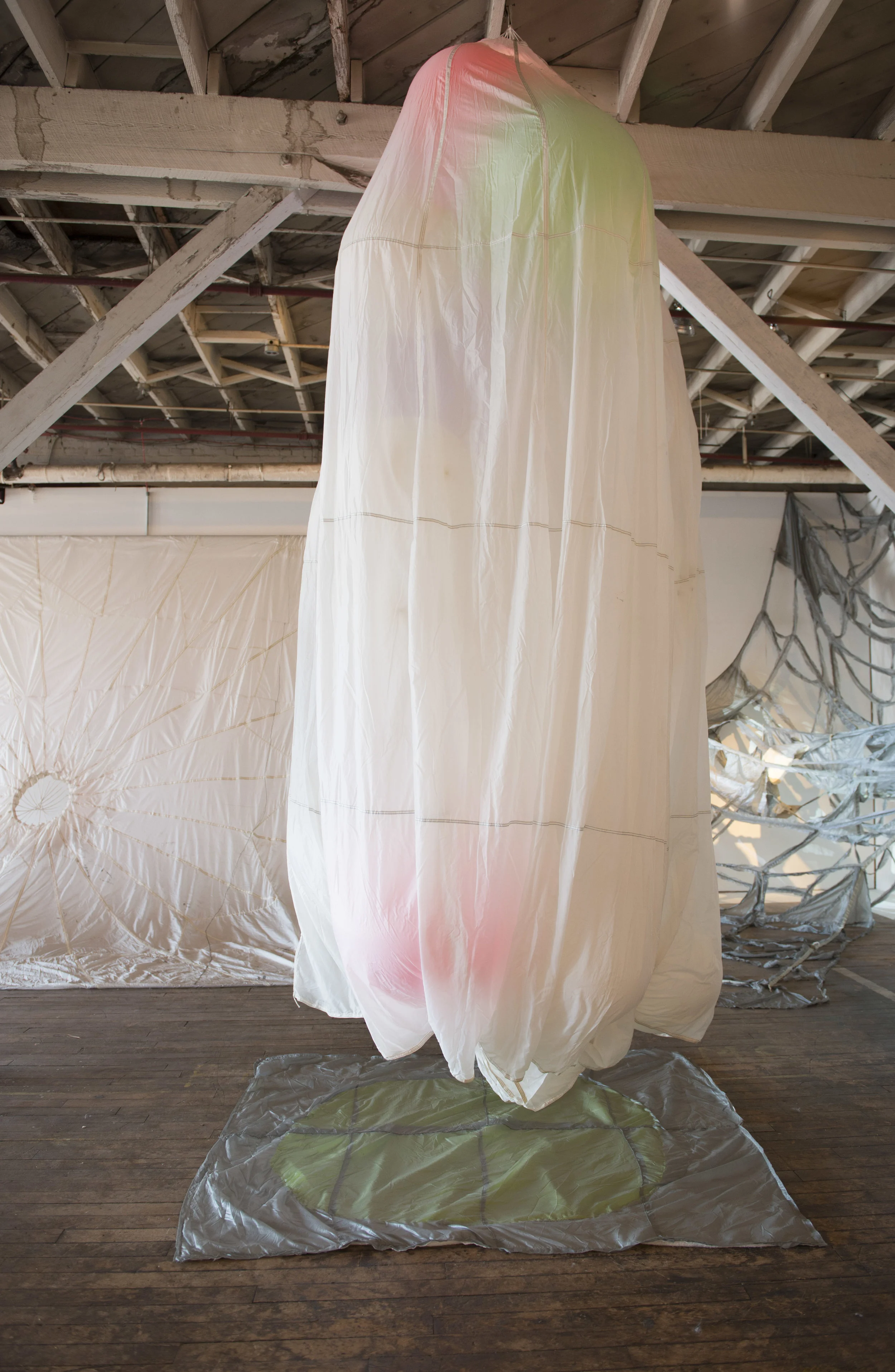 Installation view 2, Parachute I, 2016, Parachute , helium balloons, thread, batting, safety fabric, 15' X 6' X 6' (approx.)
