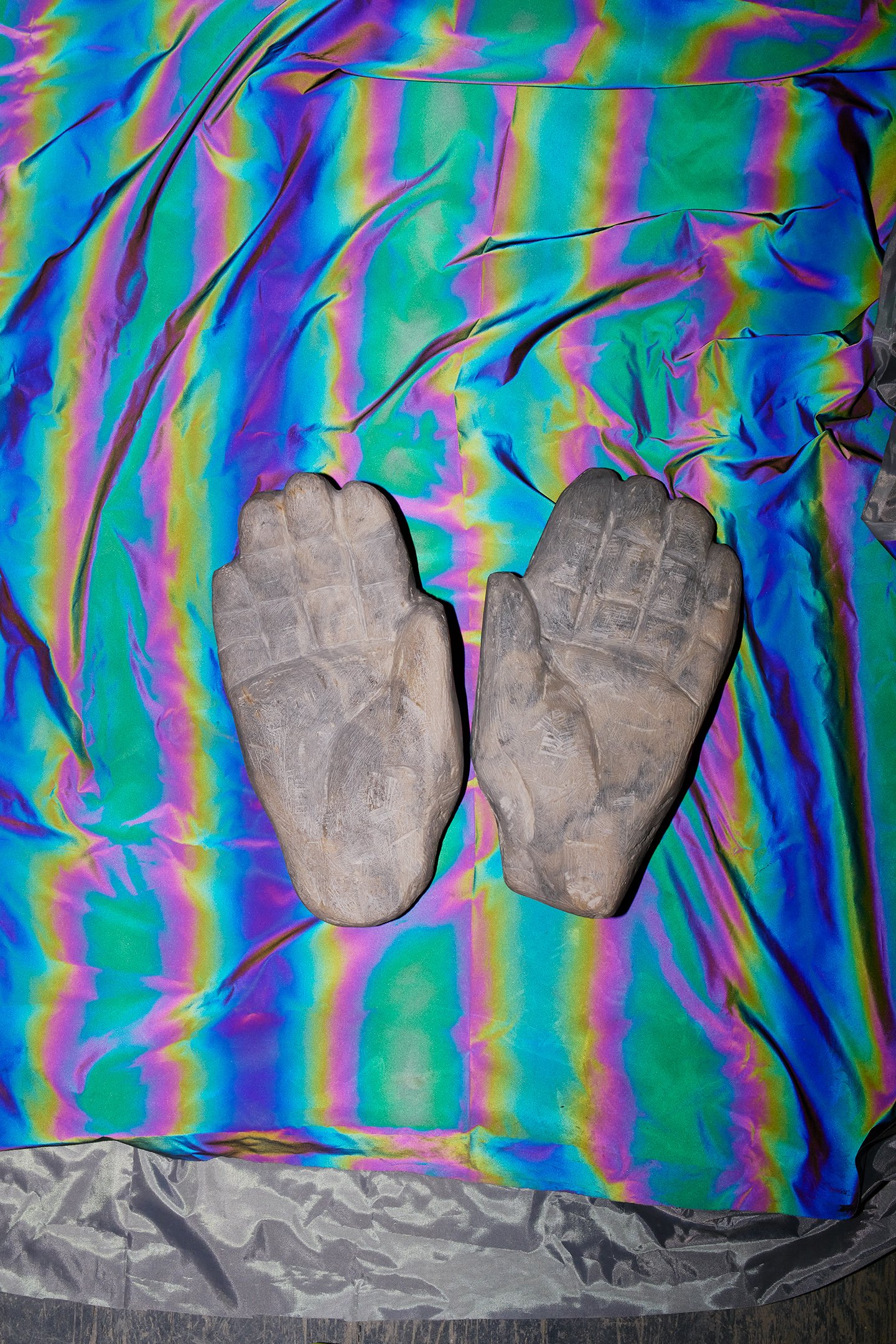  Photograph of: Hands, 2023, Soapstone, 10” X 12” X 4”  Photograph (with fabric) by Hannah Whitaker for "Dim, Dahlia, Violet, Stone" (ITI Press, 2024) 