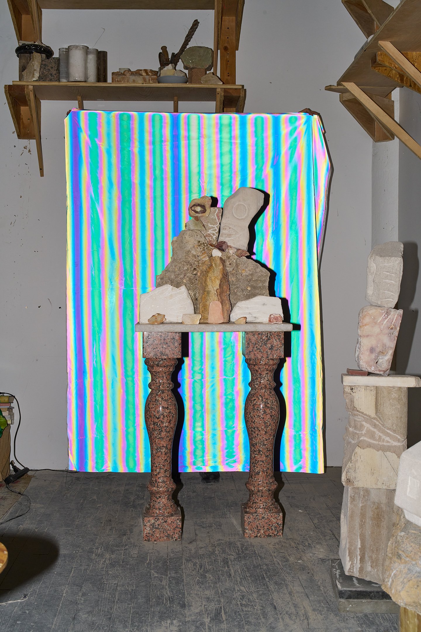  Photograph of: Figure/S III, 2023, Limestone, Soapstone, Marble, Pipe Stone, Onyx, Calcite, 57” X `4” X 24”  Photograph (with fabric) by Hannah Whitaker for "Dim, Dahlia, Violet, Stone" (ITI Press, 2024) 