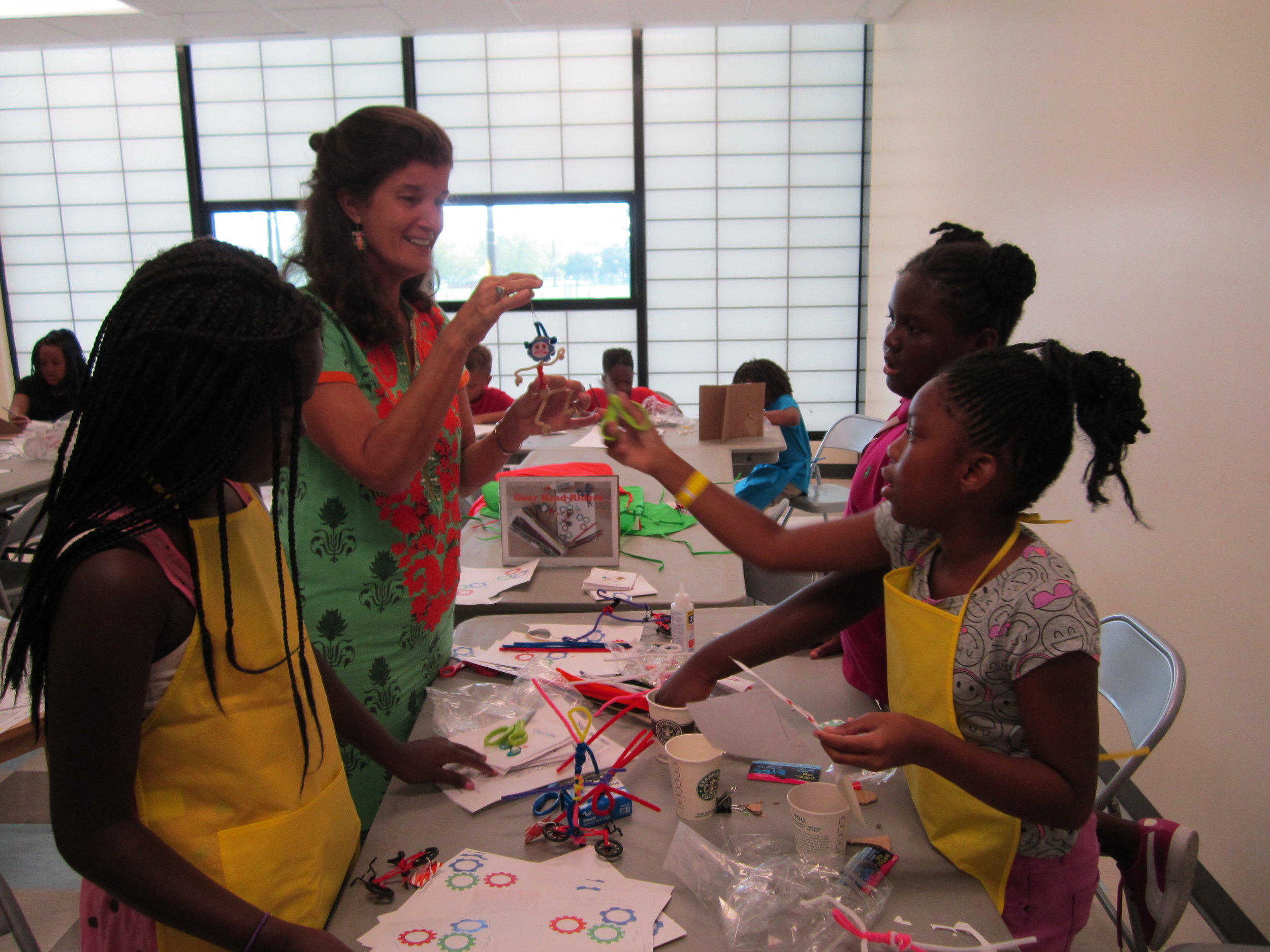 Ms. Cora works with the girls at Campbell Park Rec. Center on their sculptures.