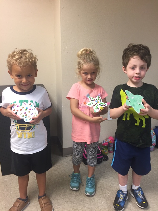 Campers showing off their unique sea animal collages.