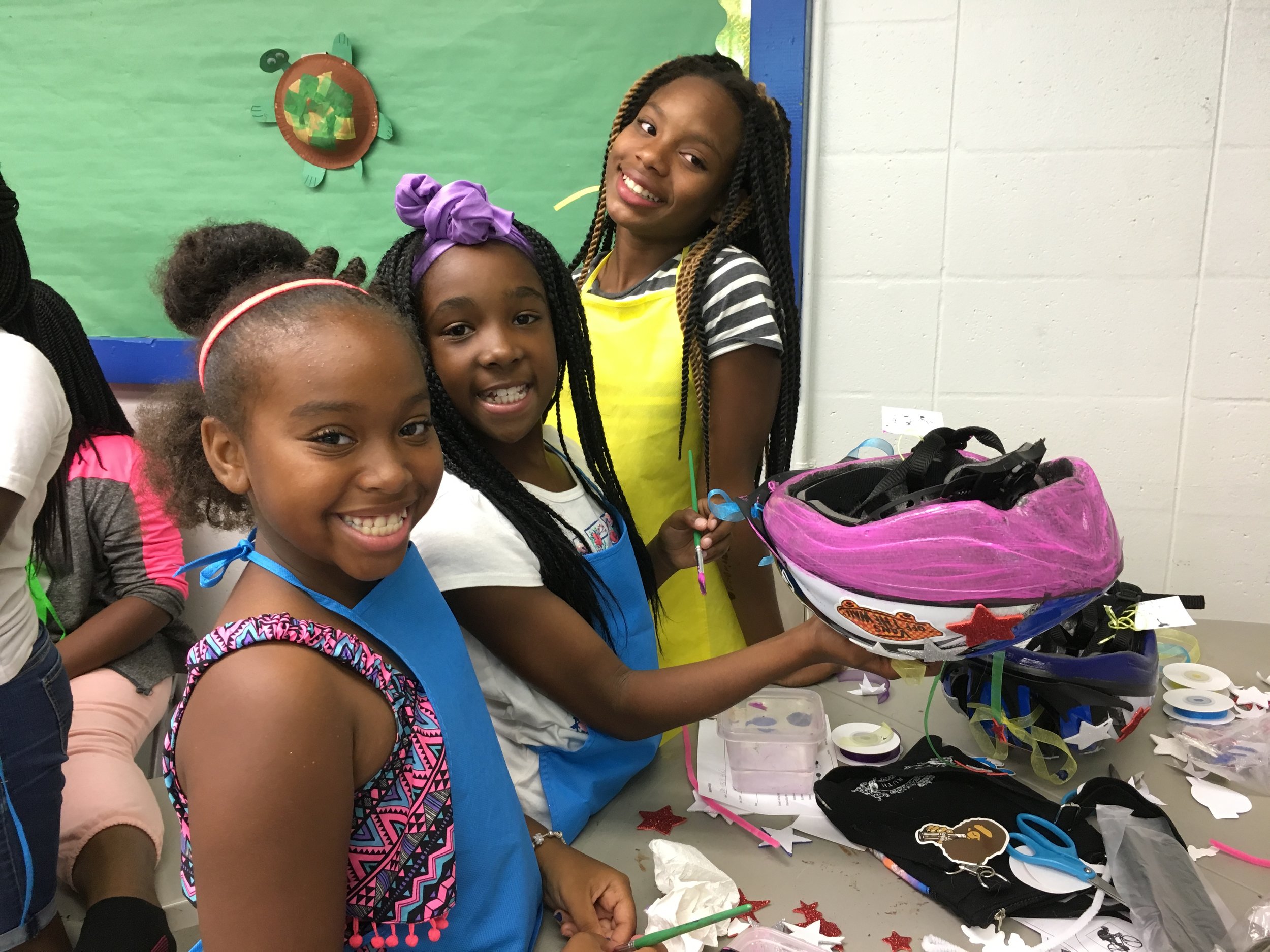 After a week's break to observe Independence Day, classes resumed on July 10 and 11 with a bang! Students at Frank Pierce Rec. Center have fun painting and decorating their very own bicycle helmet. Helmets were donated by Jeeves Law Group.