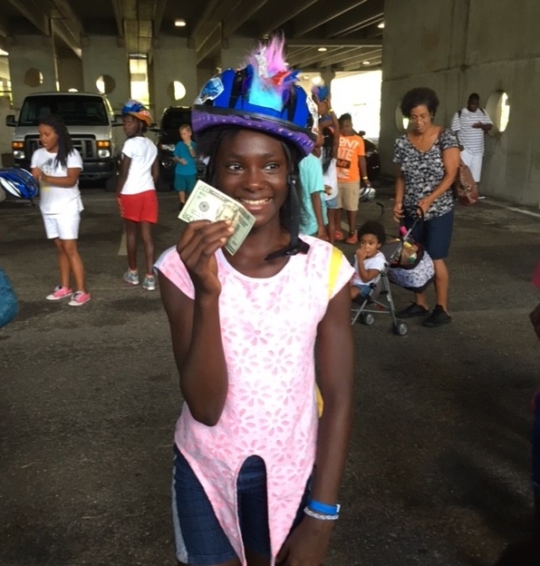 Jeeves Law Group was so impressed with the decorated helmets that they awarded a spontaneous $10 and $20 prize for the helmets they felt were the most outstanding. Pictured is one happy winner!