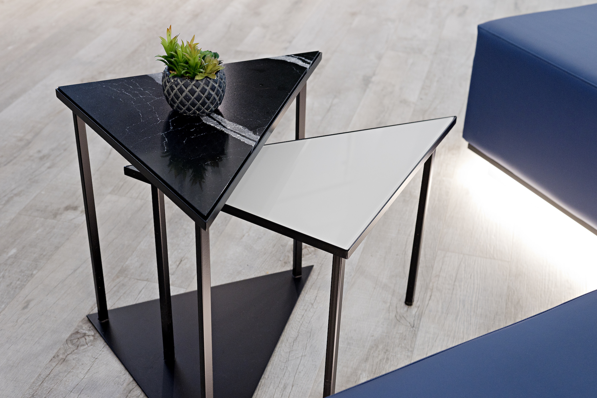 3 pizzale design interior design commercial triangle table quartz metal nesting tables succulent blue bench led lighting black accent custom grey laminate flooring.jpg