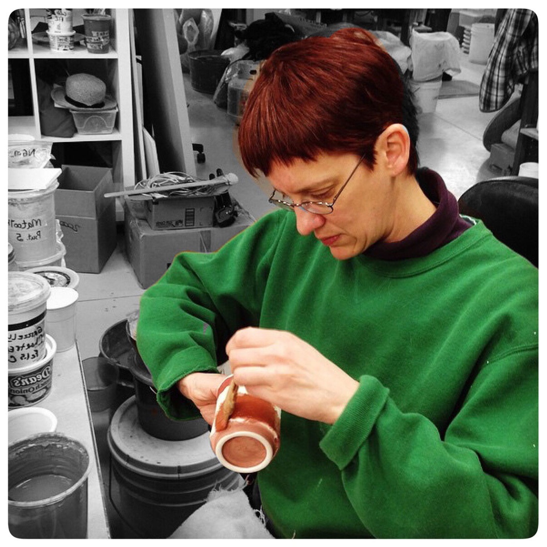 Copy of Samantha Henneke brushing glaze on a cup in the Bulldog Pottery studio | Seagrove | North Carolina