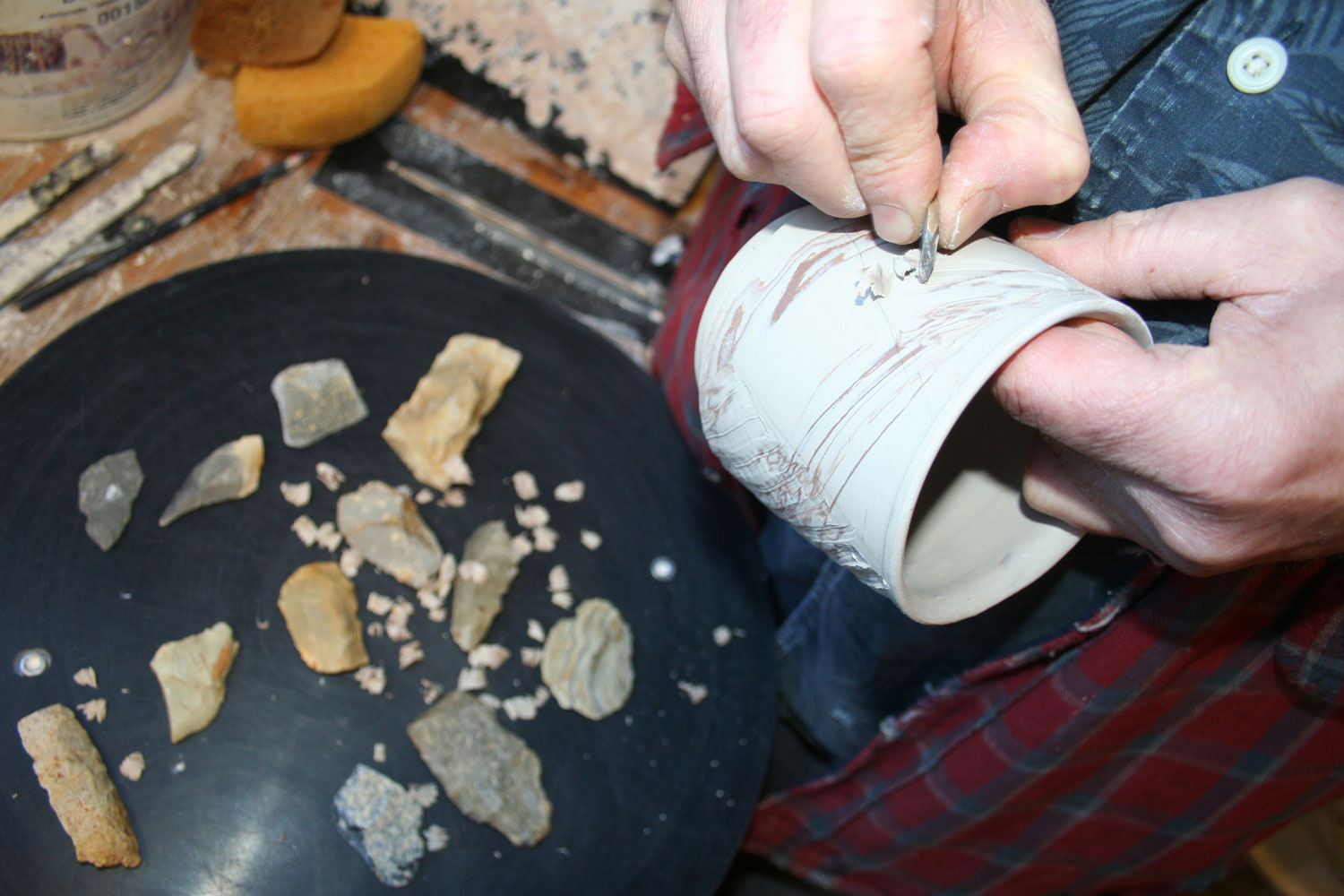Bruce carving one of his cups with a blade of a broken arrowhead | Bulldog Pottery | Seagrove | North Carolina