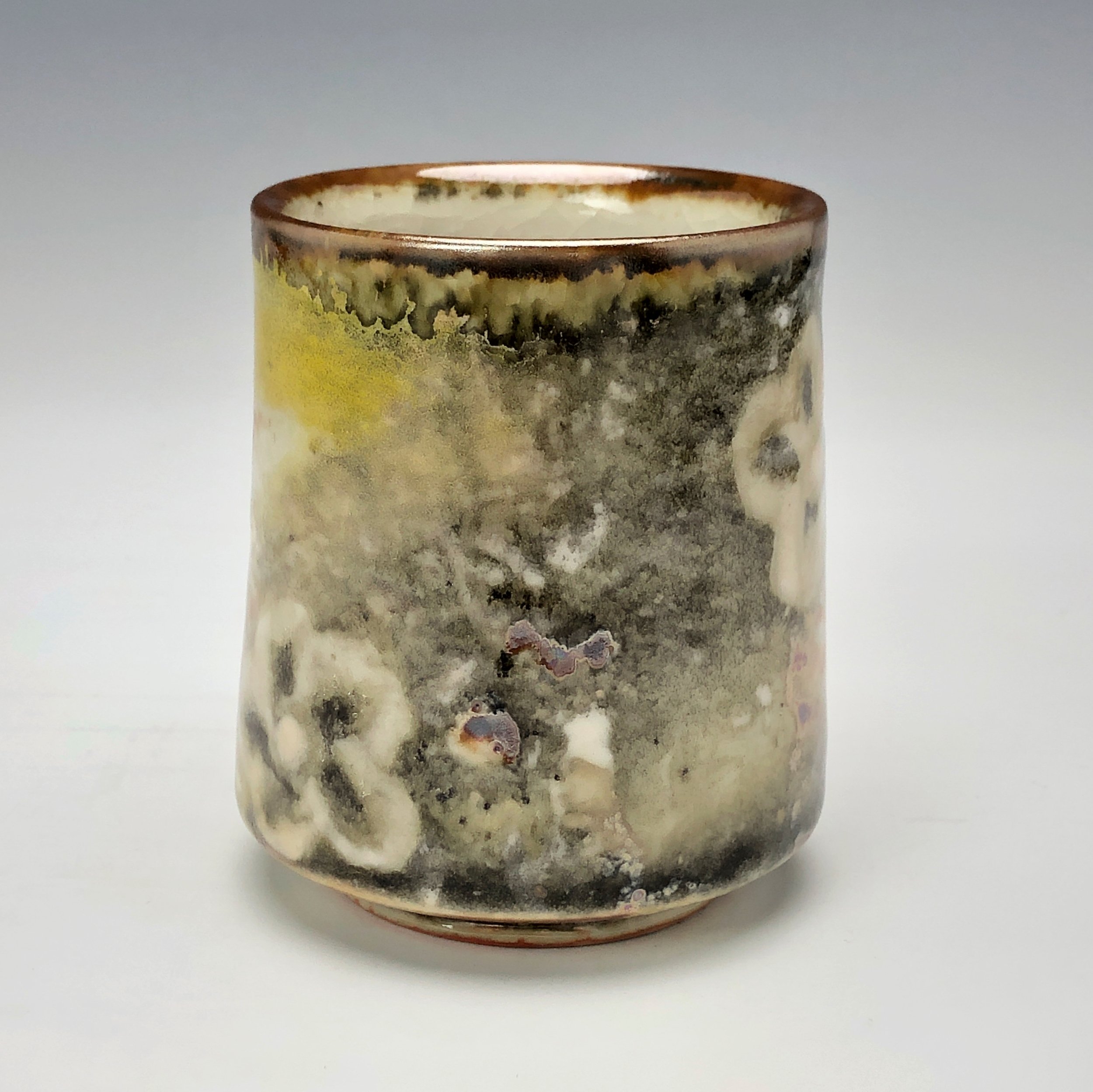  Bruce Gholson, Bulldog Pottery, Seagrove, North Carolina   Yunomi 5  - Casual drinking cup made from porcelain with Iron Luster Fish. Ceramic cup also has swipes of yellow and blue. A textural shino is also glazed onto the some areas of the cup’s su