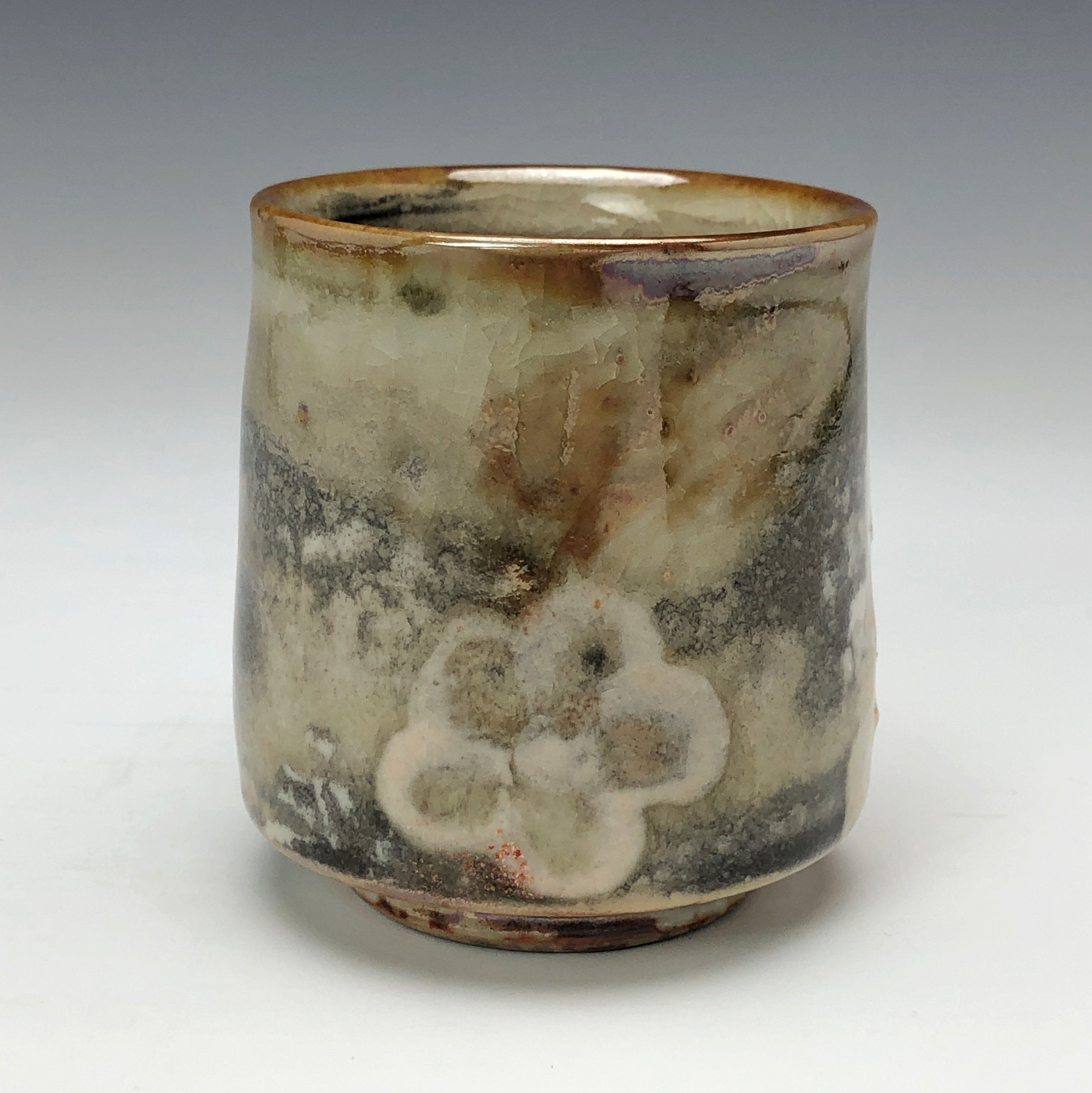  Bruce Gholson, Bulldog Pottery, Seagrove, North Carolina   Yunomi 5  - Casual drinking cup made from porcelain with Iron Luster Fish. Ceramic cup also has swipes of yellow and blue. A textural shino is also glazed onto the some areas of the cup’s su