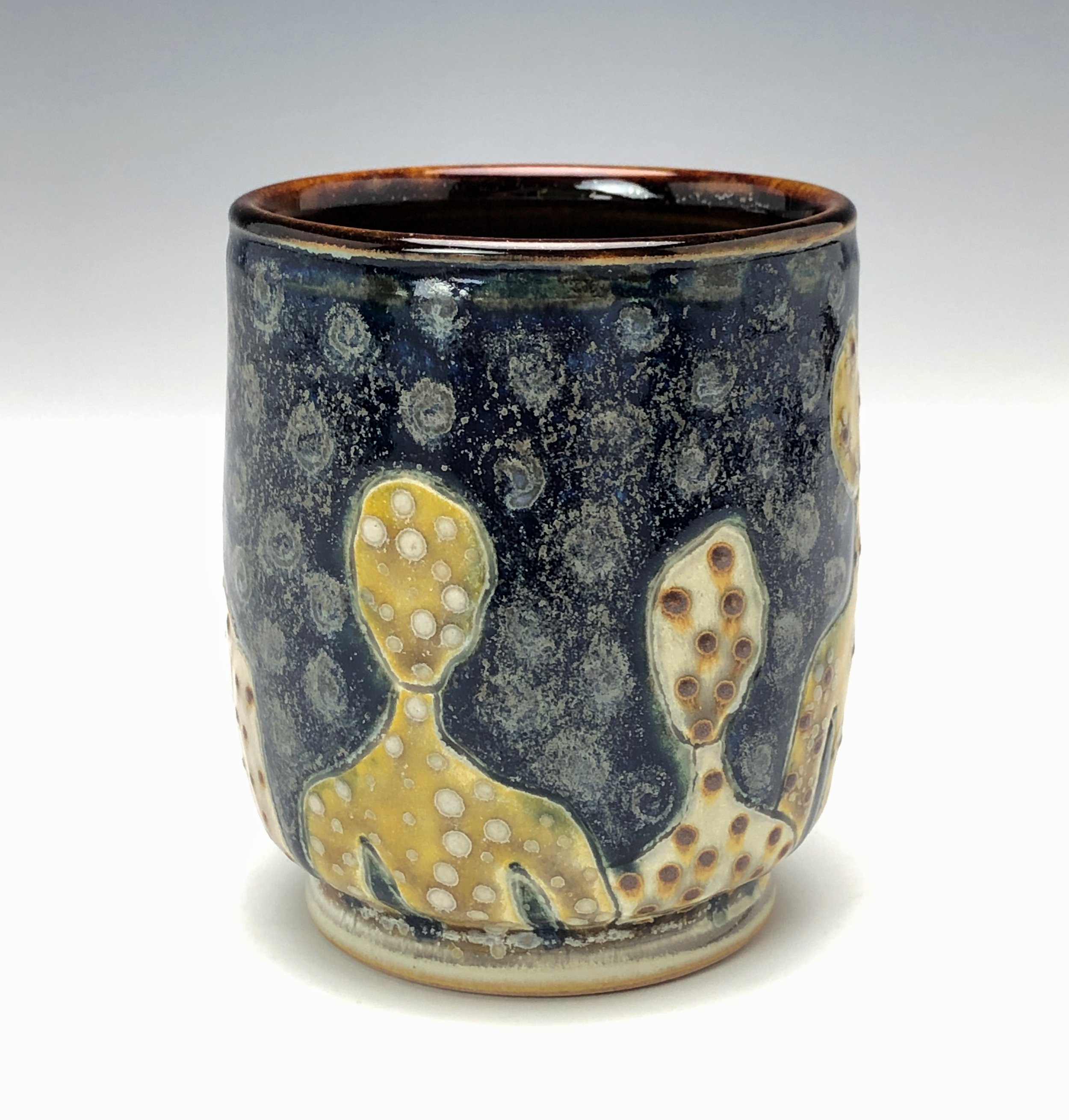  Samantha Henneke, Bulldog Pottery, Seagrove, North Carolina  Yunomi 4- Casual drinking cup made from a smooth white porcelaneous clay body. Figurative decoration with slip and glaze dot patterns. Translucent vellum glaze over various underglaze colo