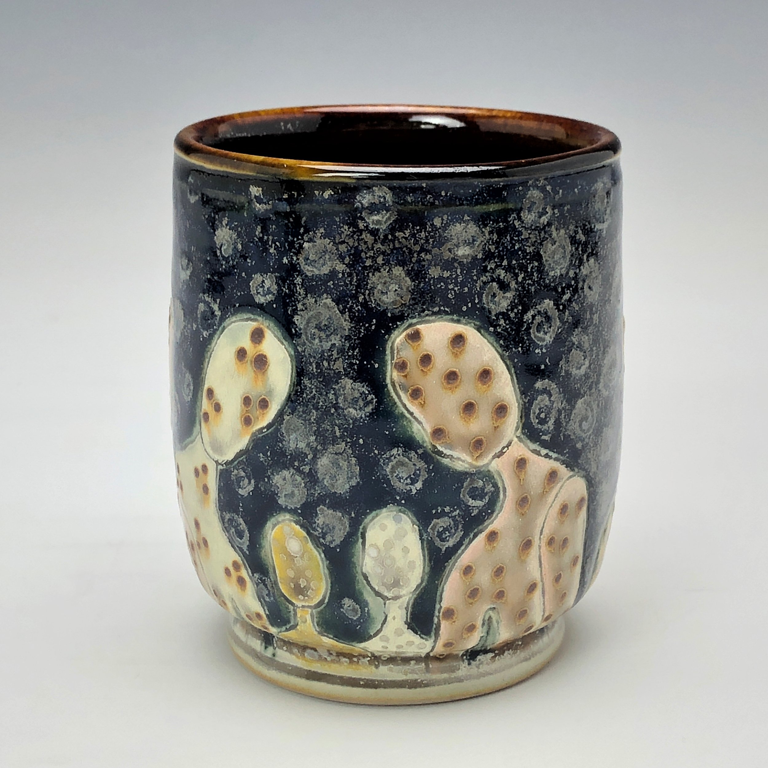  Samantha Henneke, Bulldog Pottery, Seagrove, North Carolina  Yunomi 4- Casual drinking cup made from a smooth white porcelaneous clay body. Figurative decoration with slip and glaze dot patterns. Translucent vellum glaze over various underglaze colo