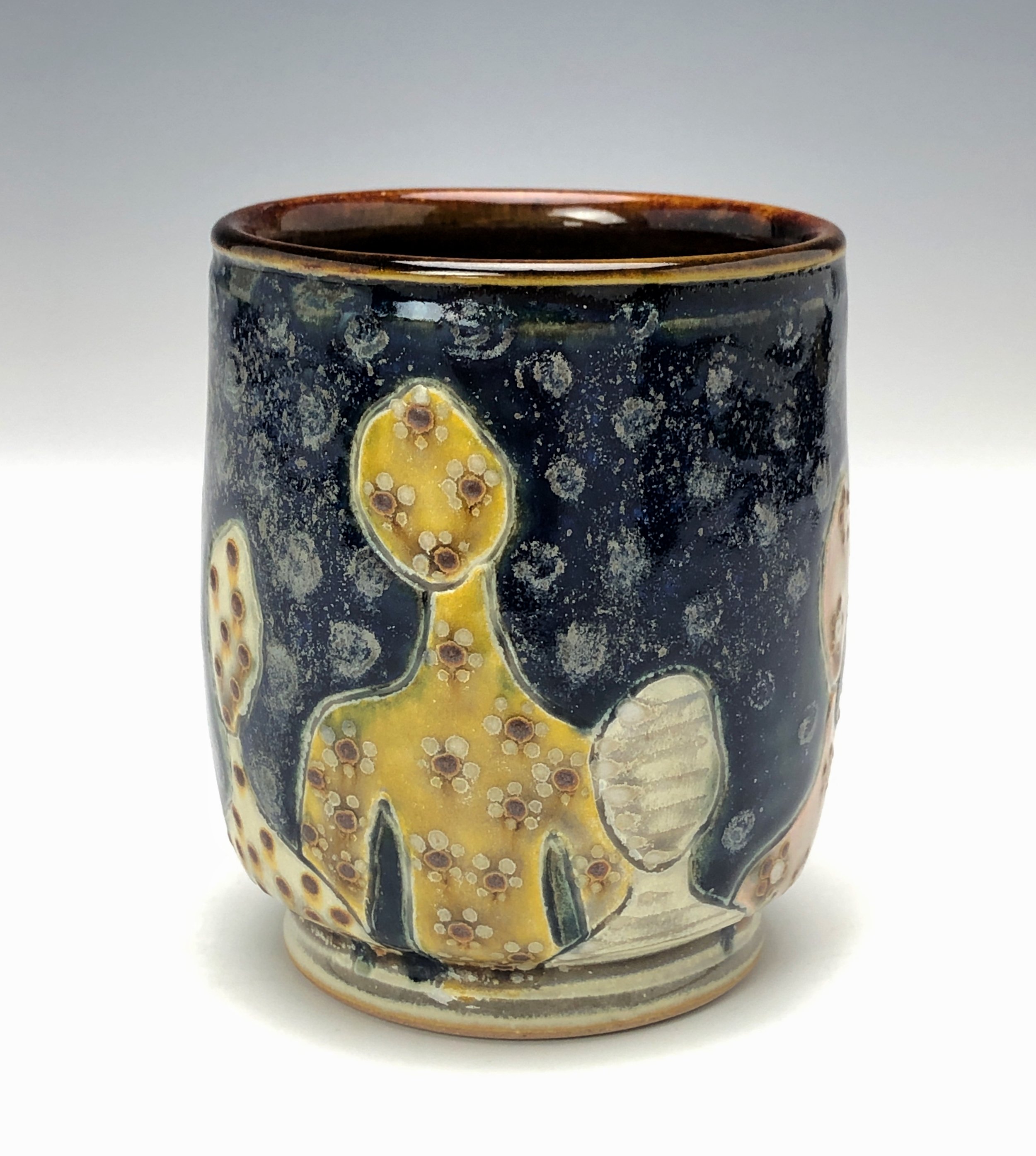  Samantha Henneke, Bulldog Pottery, Seagrove, North Carolina  Yunomi 4- Casual drinking cup made from a smooth white porcelaneous clay body. Figurative decoration with slip and glaze dot patterns. Translucent vellum glaze over various underglaze colo